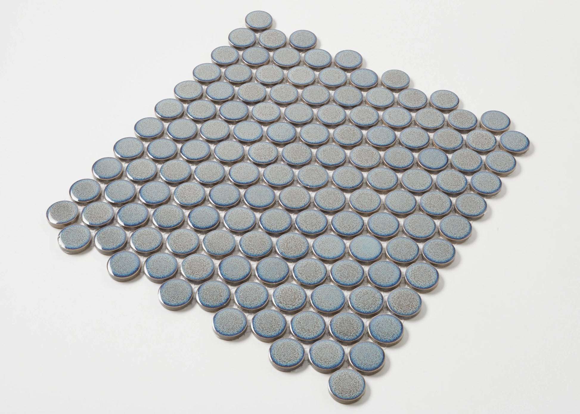 Pack shot of Mottled Grey Gloss Glazed Porcelain Penny Round 28mm Diameter tiles arranged in a diamond formation, showcasing their circular shape, speckled grey glaze, and blue-edged rims.