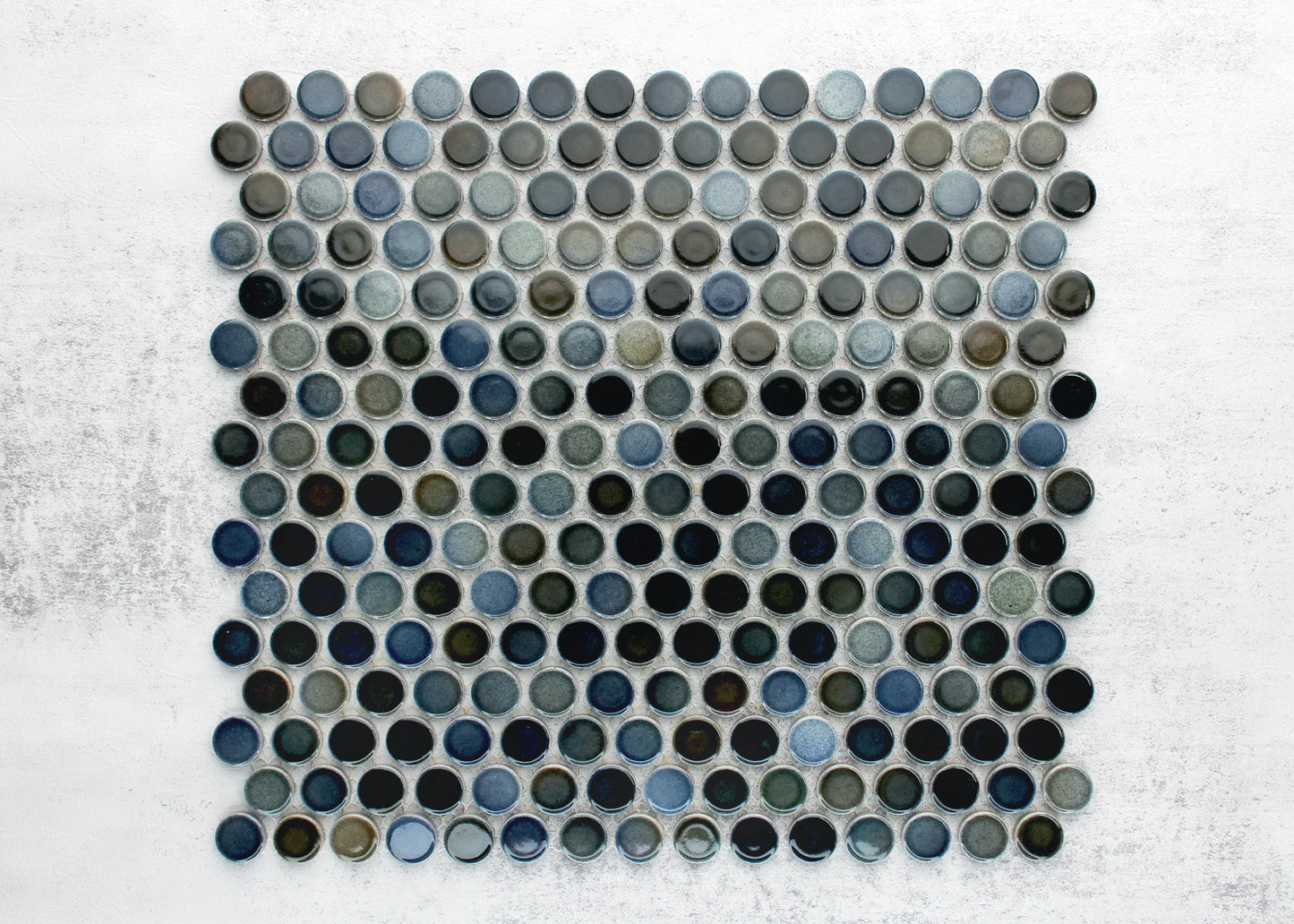Pack shot of Mottled Mix Gloss Diameter Glazed Porcelain Penny Round 19mm tiles showing a mosaic sheet of glossy circular penny rounds in varied blue, grey, and dark teal glazes on a white background.