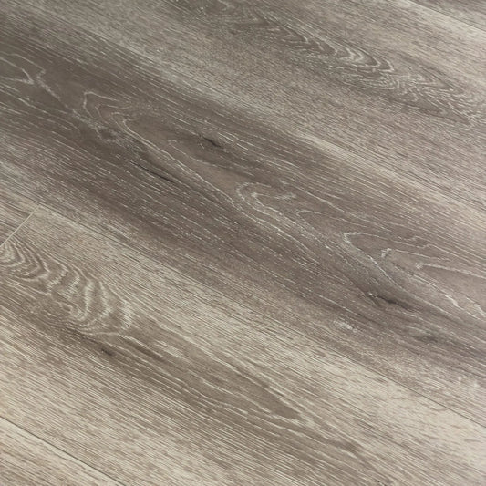 Close-up texture shot of Mystic Grey Urban Laminate 12mm Flooring 12mm showing detailed grey wood grain pattern with natural knots and subtle white streaking.