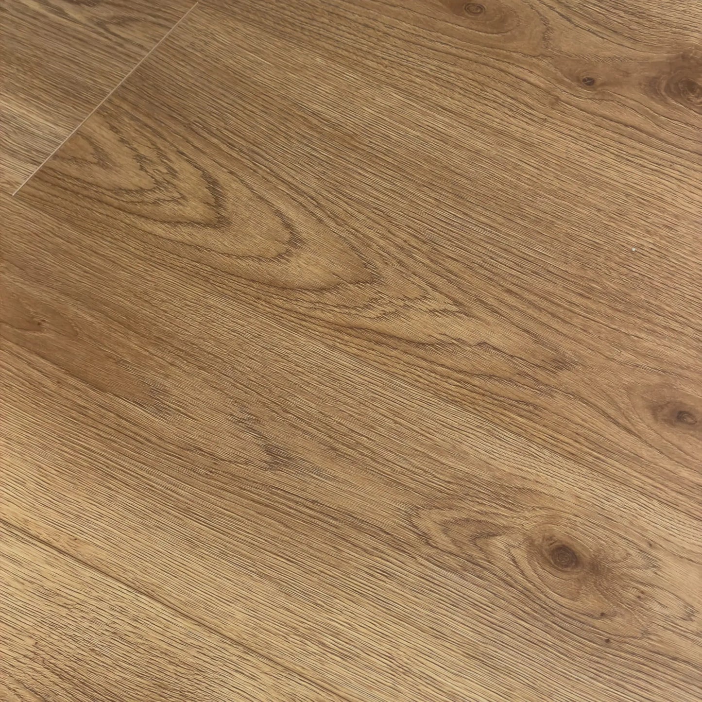 Close-up of Natural Oak Urban Laminate 12mm Flooring 12mm showing warm honey-toned wood grain, natural knots, and fine linear texture detail.