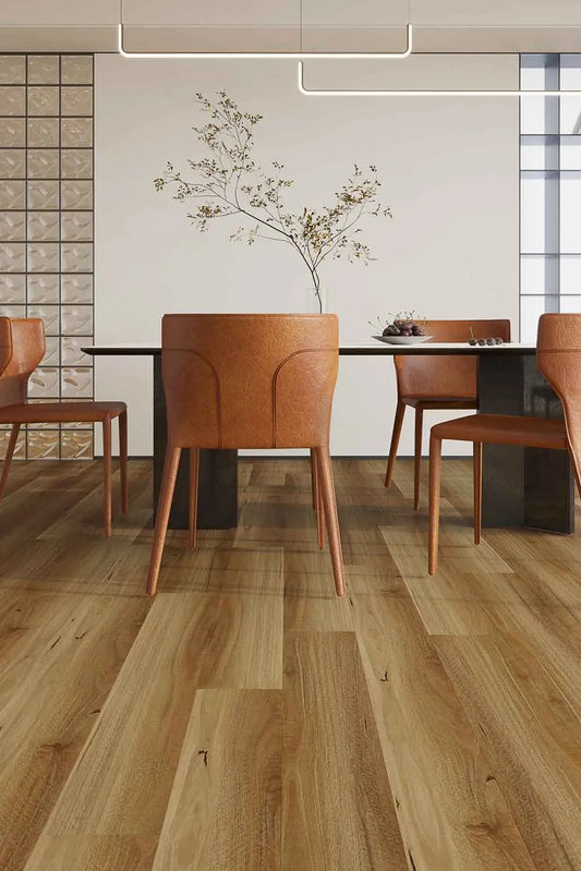 Natural Spotted Gum Elegant SPC Hybrid 9.5mm Flooring 7.5+2mm installed in a modern dining room with tan leather chairs and a pendant light.