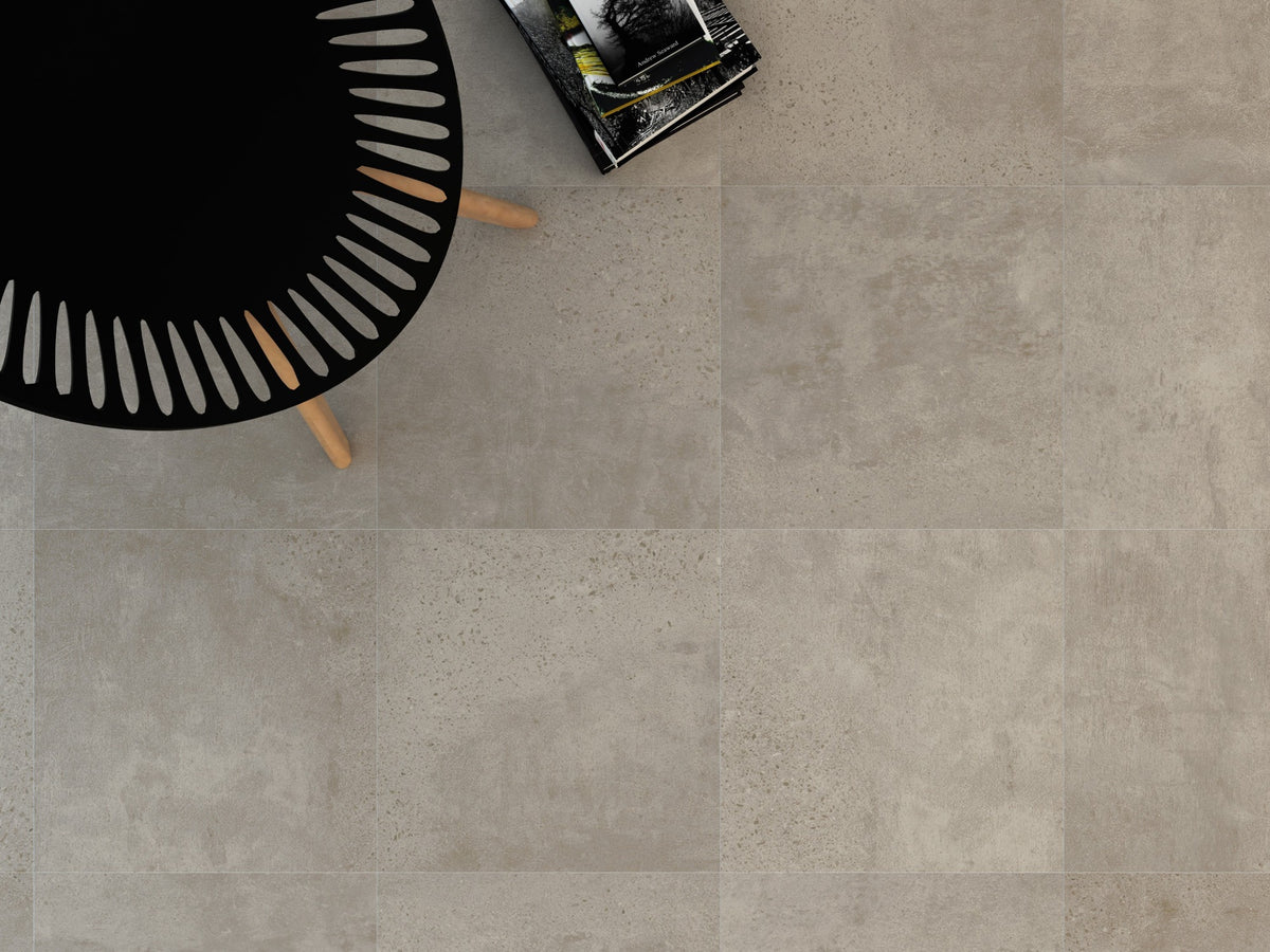 New York White Matt 300x300mm porcelain floor tiles installed in a modern living space with a black decorative side table and stacked books.