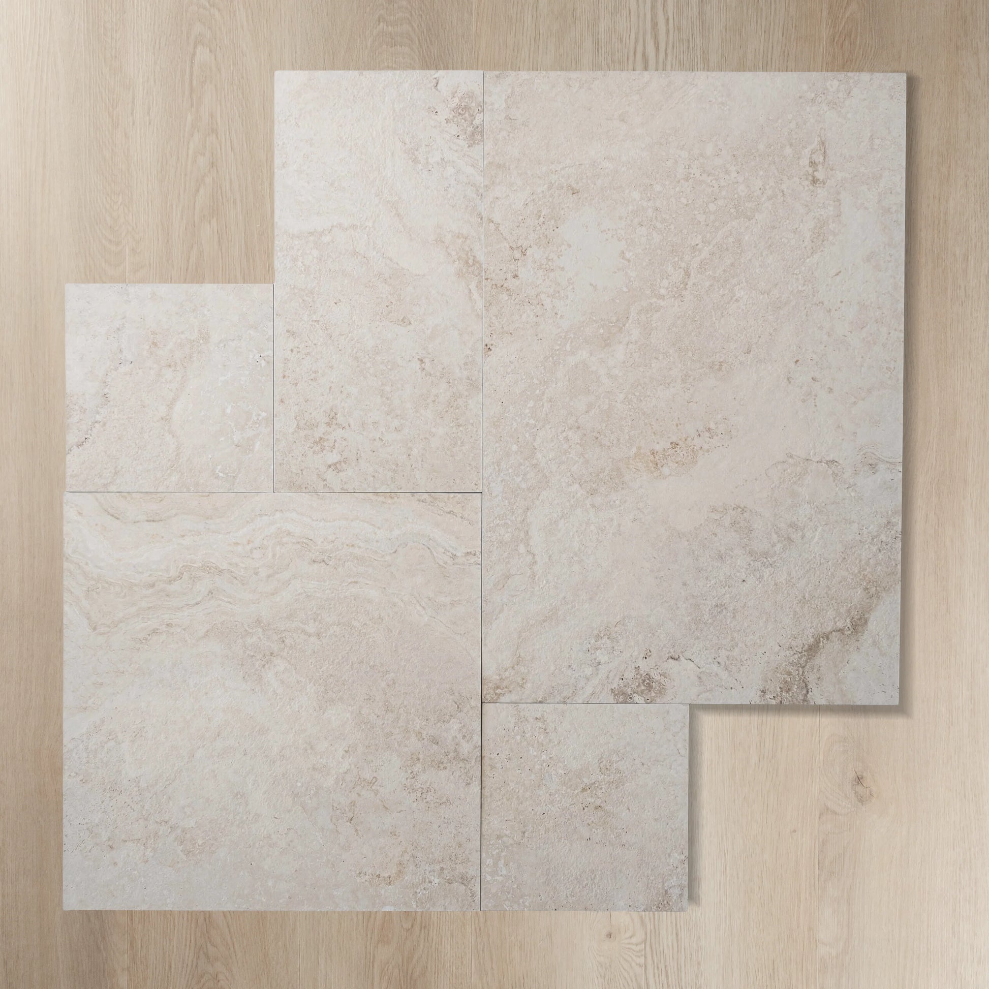 Four tiles of Norcia Beige French Pattern 400x600mm displayed in a staggered layout showing the natural stone-look texture and warm cream tones.
