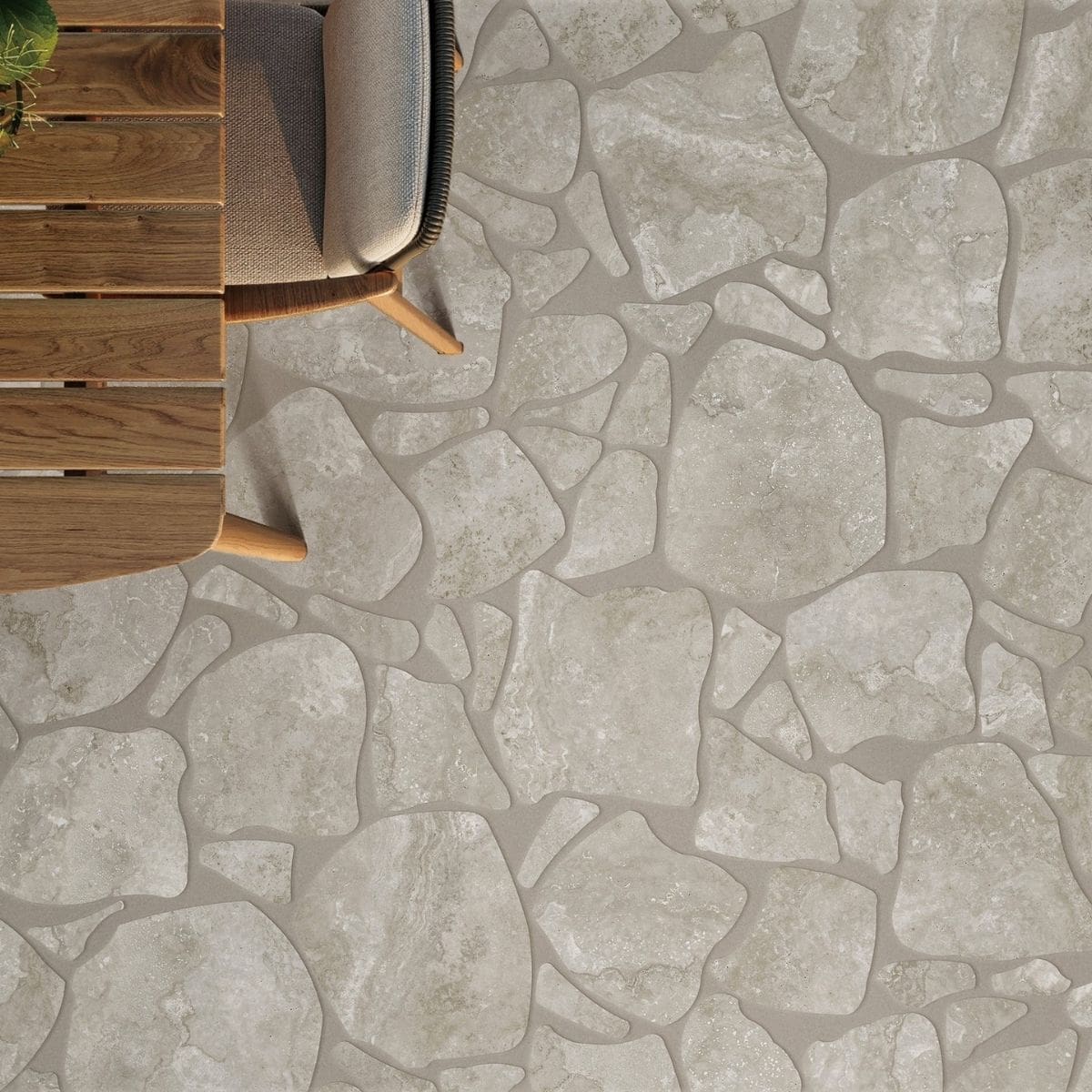 Norcia Grey Crazy Pave 600x600mm porcelain tiles installed on an outdoor patio floor beside a timber lounge chair and wooden deck furniture.