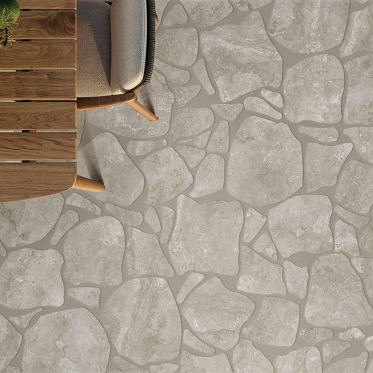 Norcia Grey Crazy Pave 600x600mm porcelain tiles installed on an outdoor patio floor beside a timber lounge chair and wooden deck furniture.