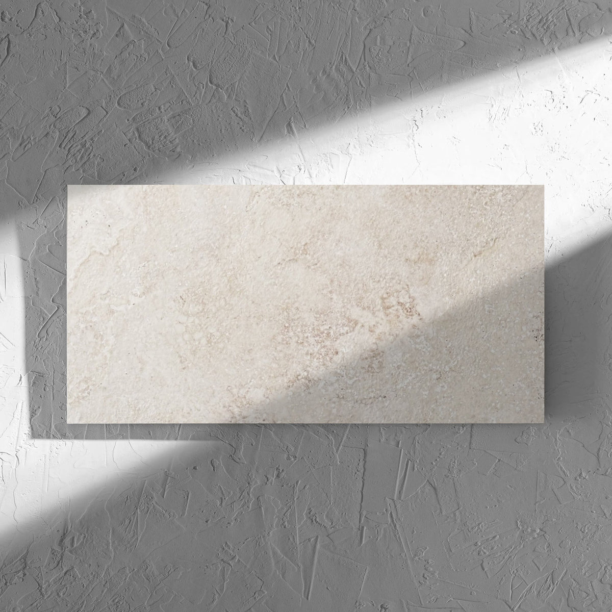 Norcia Travertine Beige 300x600mm tile in soft natural window light, showing the beige travertine surface