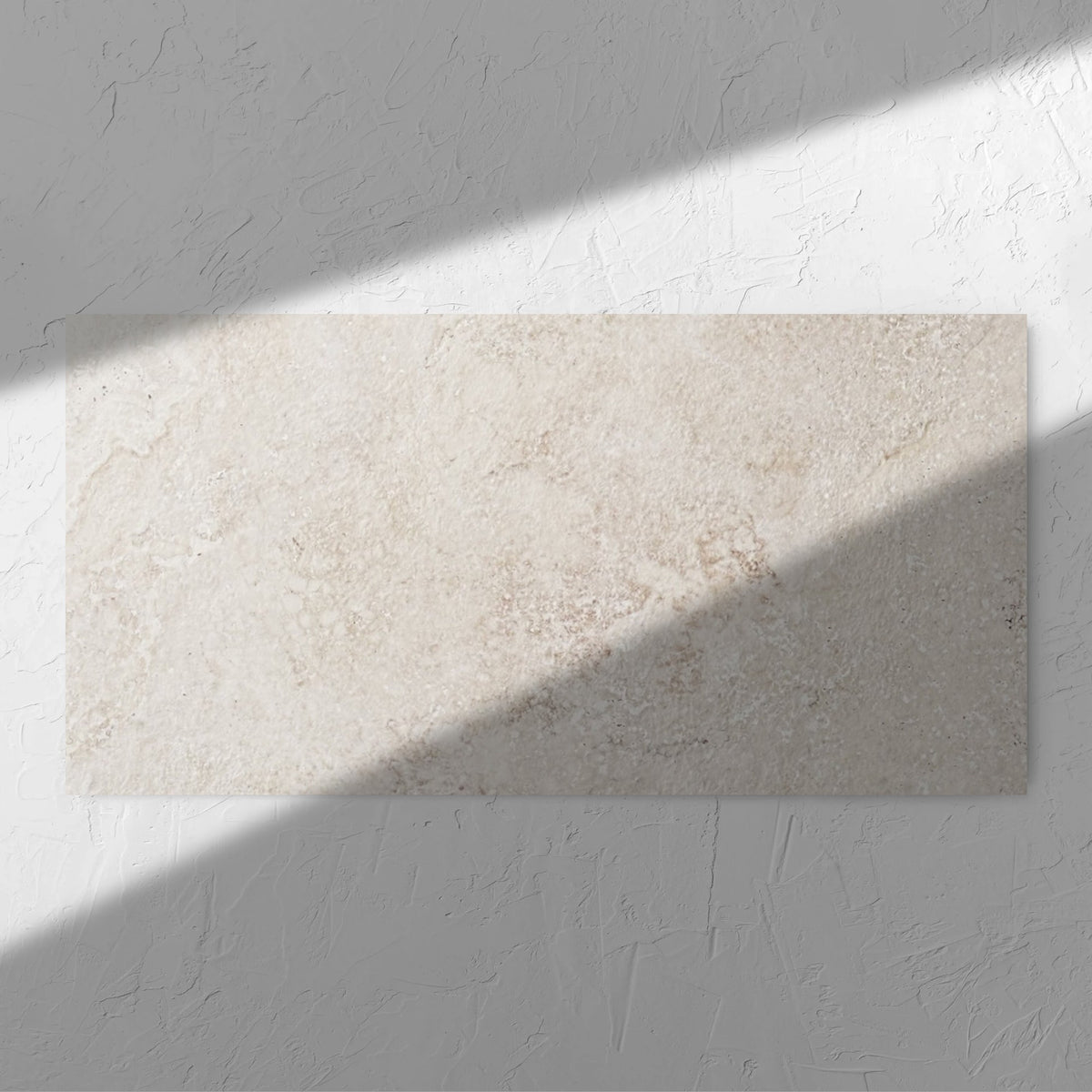 Norcia Travertine Beige 600x1200mm tile in soft natural window light, showing the beige travertine surface