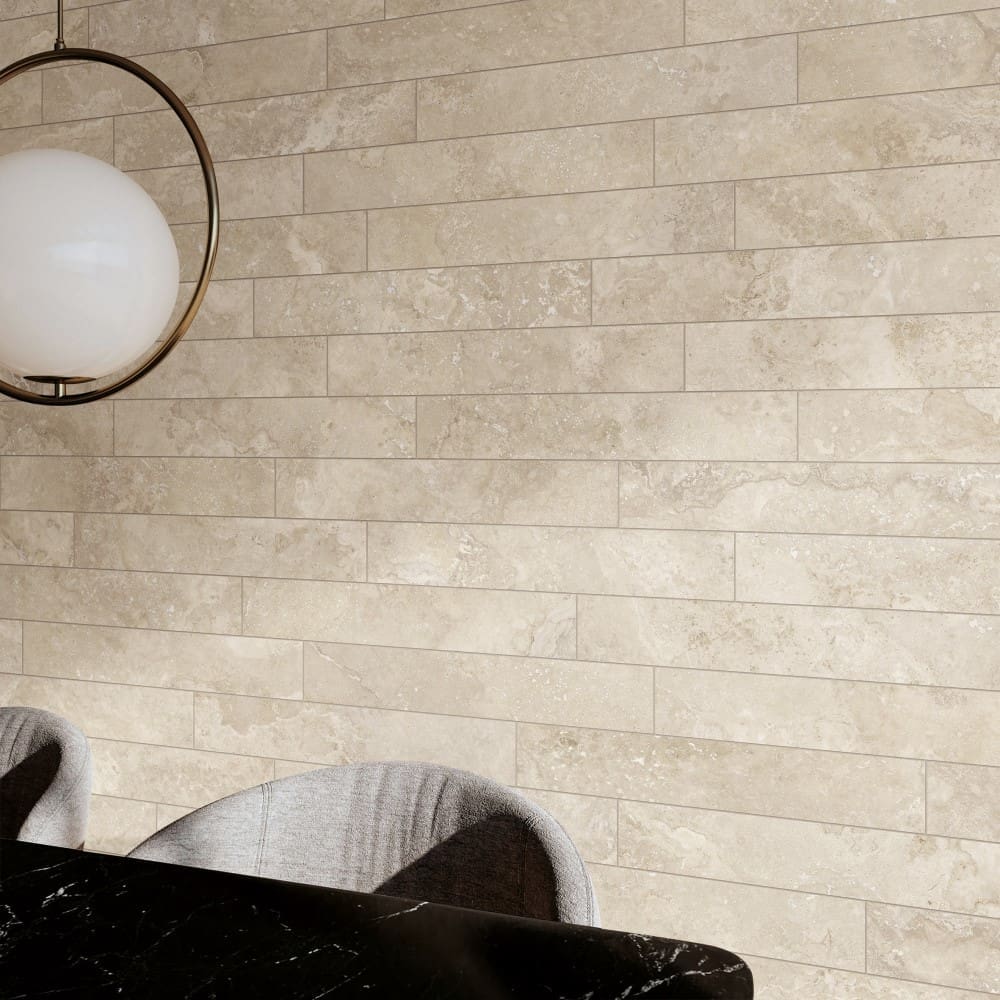 Norcia Travertine Beige Bamboo Feature 600x1200mm tiles installed as a full-height dining room feature wall, styled with a globe pendant light and black marble table.