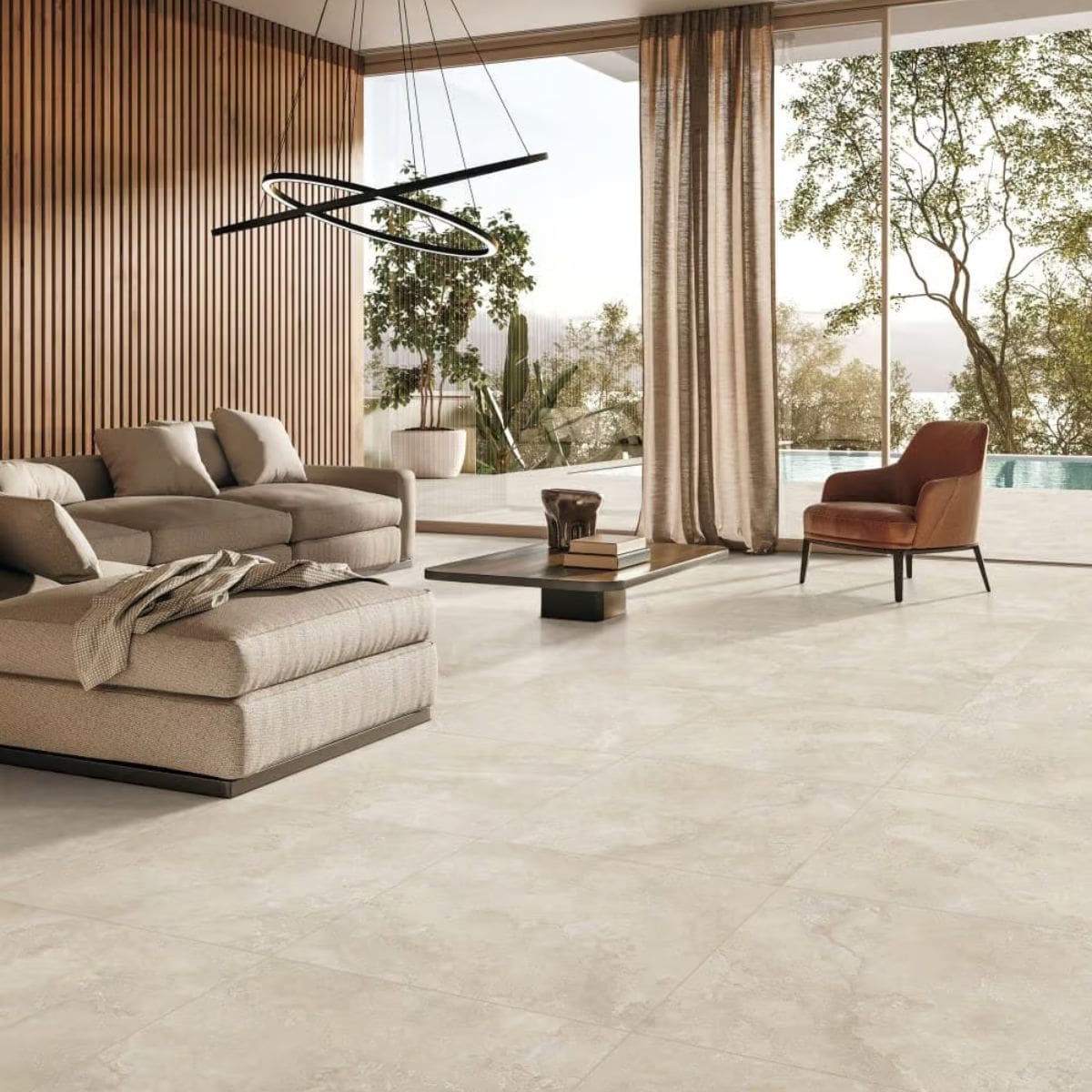 Norcia Travertine Beige Decor 300x600mm laid as a large-format beige floor in a contemporary open-plan living room with sectional sofa and pendant light.