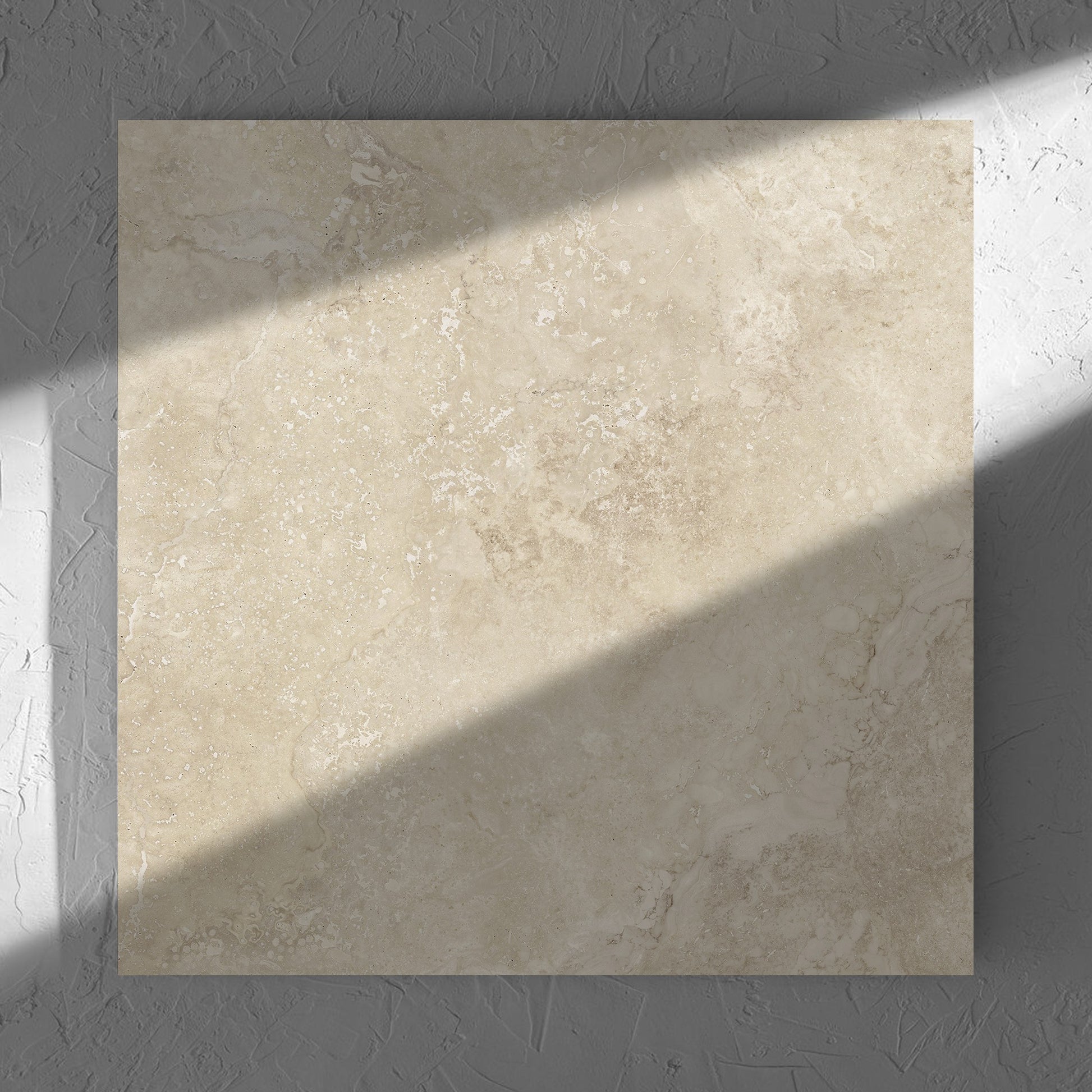 Norcia Travertine Beige Honed 600x600mm tile in soft natural window light, showing the tile surface