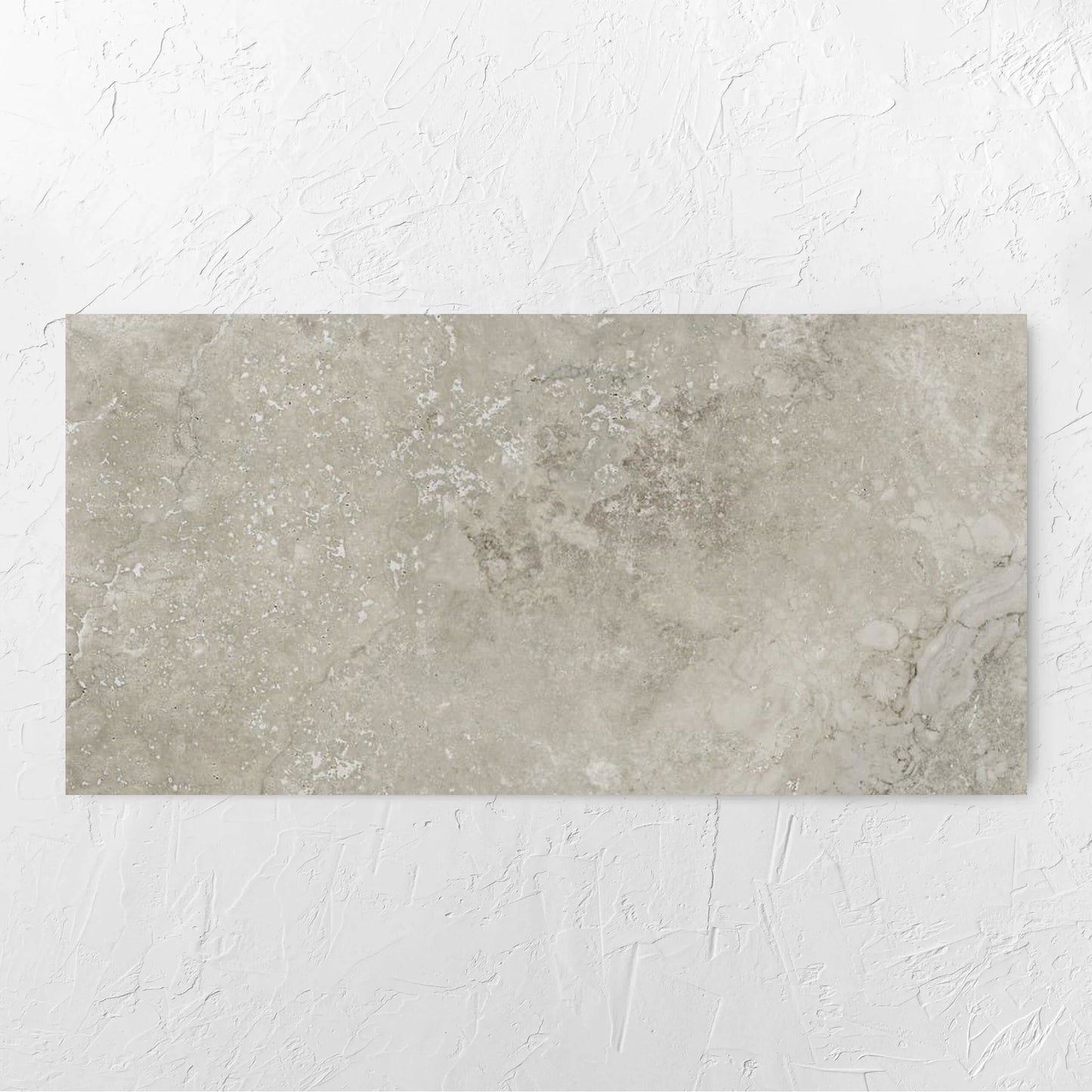 Norcia Travertine Grey 600x1200mm tile laid flat on a white rendered wall, showing the tile surface