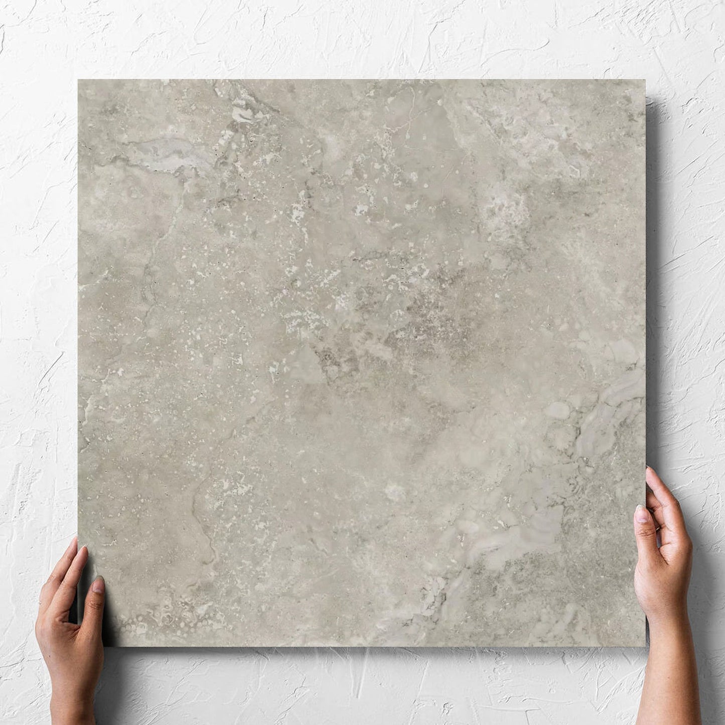 Norcia Travertine Grey 600x600mm held in hand