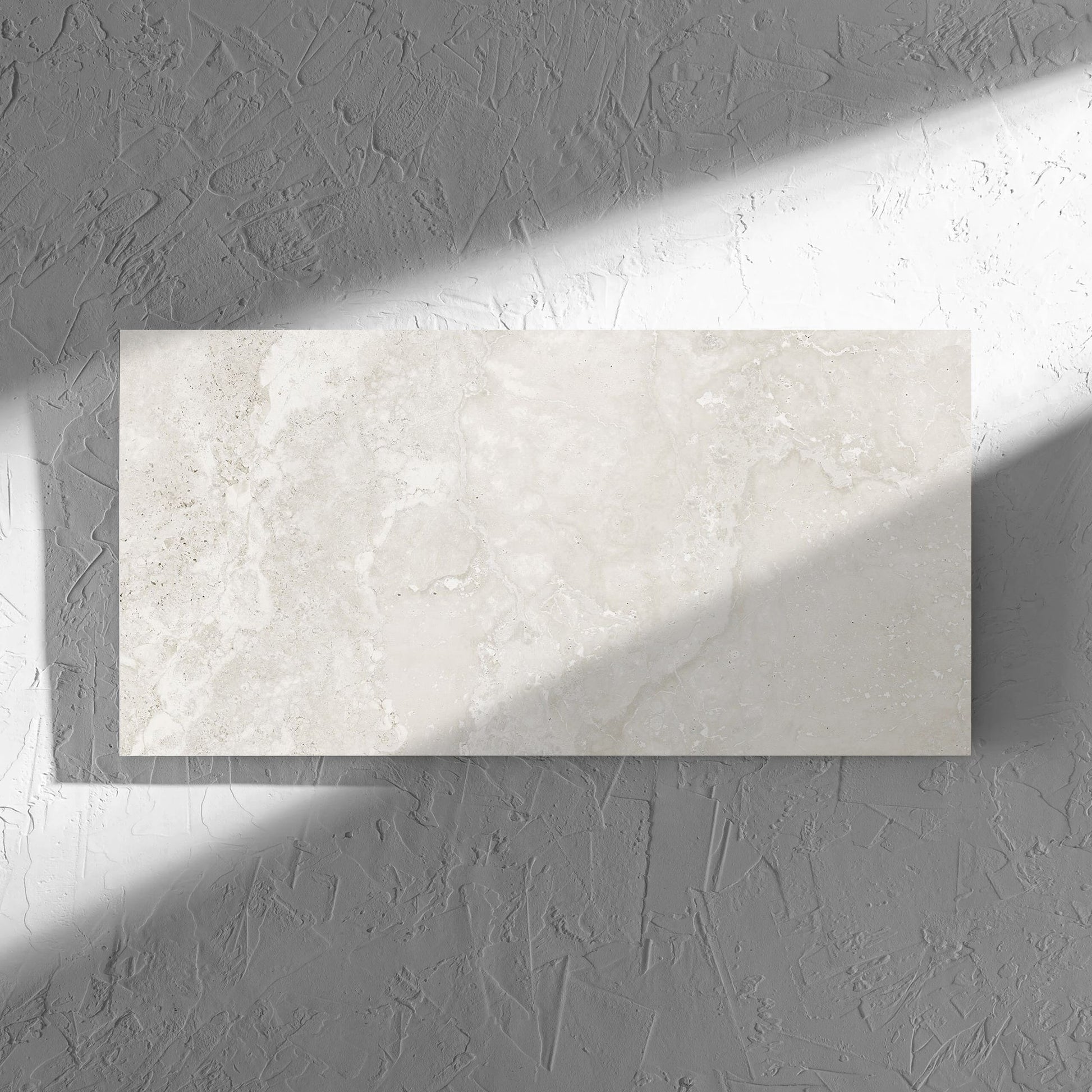 Norcia Travertine Light 300x600mm tile in soft natural window light, showing the tile surface