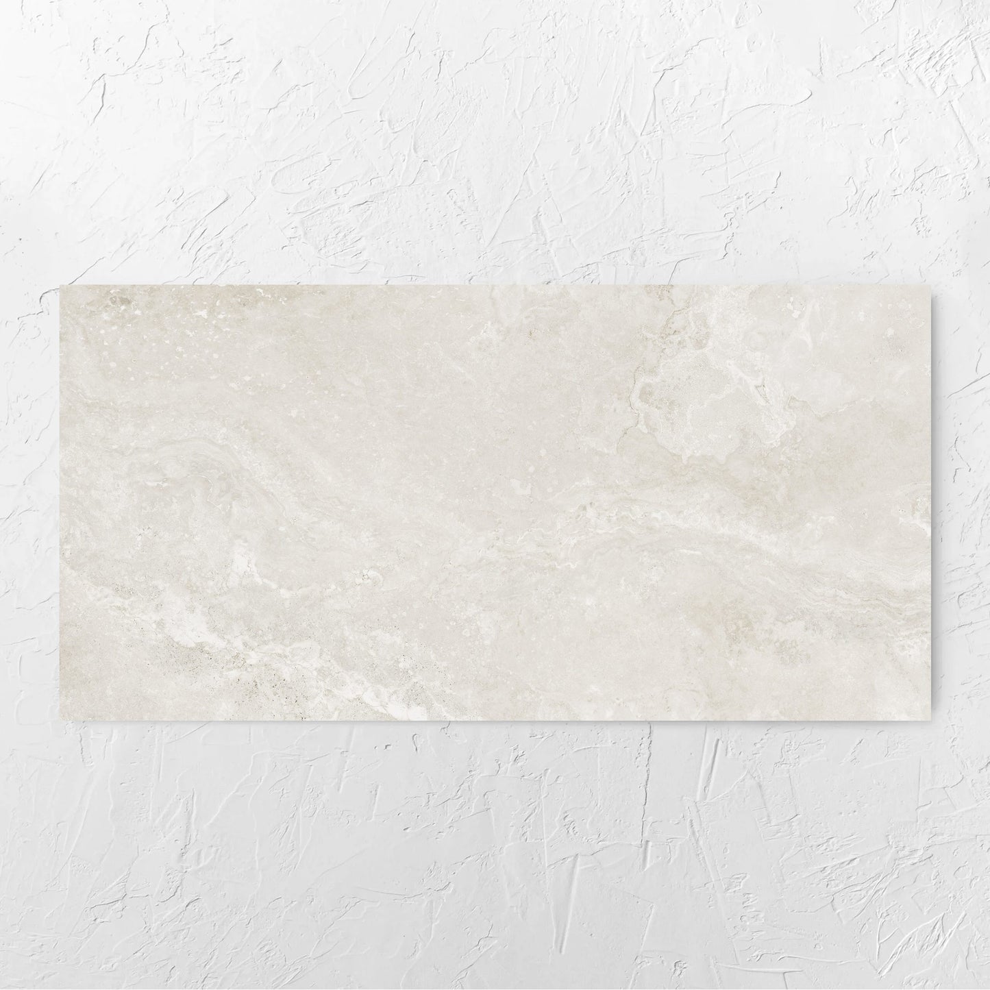 Norcia Travertine Light 600x1200mm tile laid flat on a white rendered wall, showing the tile surface