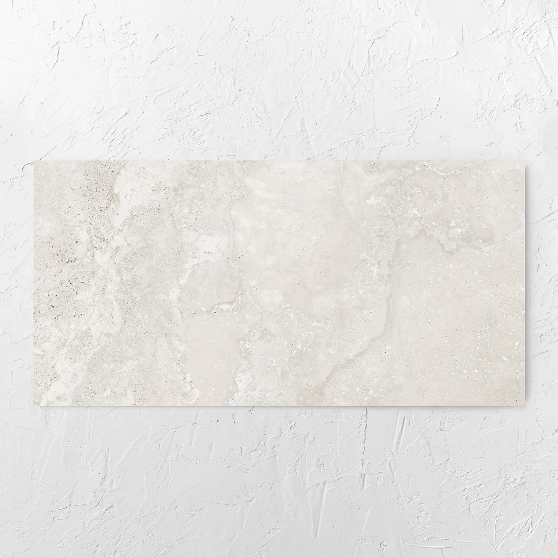 Norcia Travertine Light Bamboo Feature 600x1200mm tile laid flat on a white rendered wall, showing the tile surface