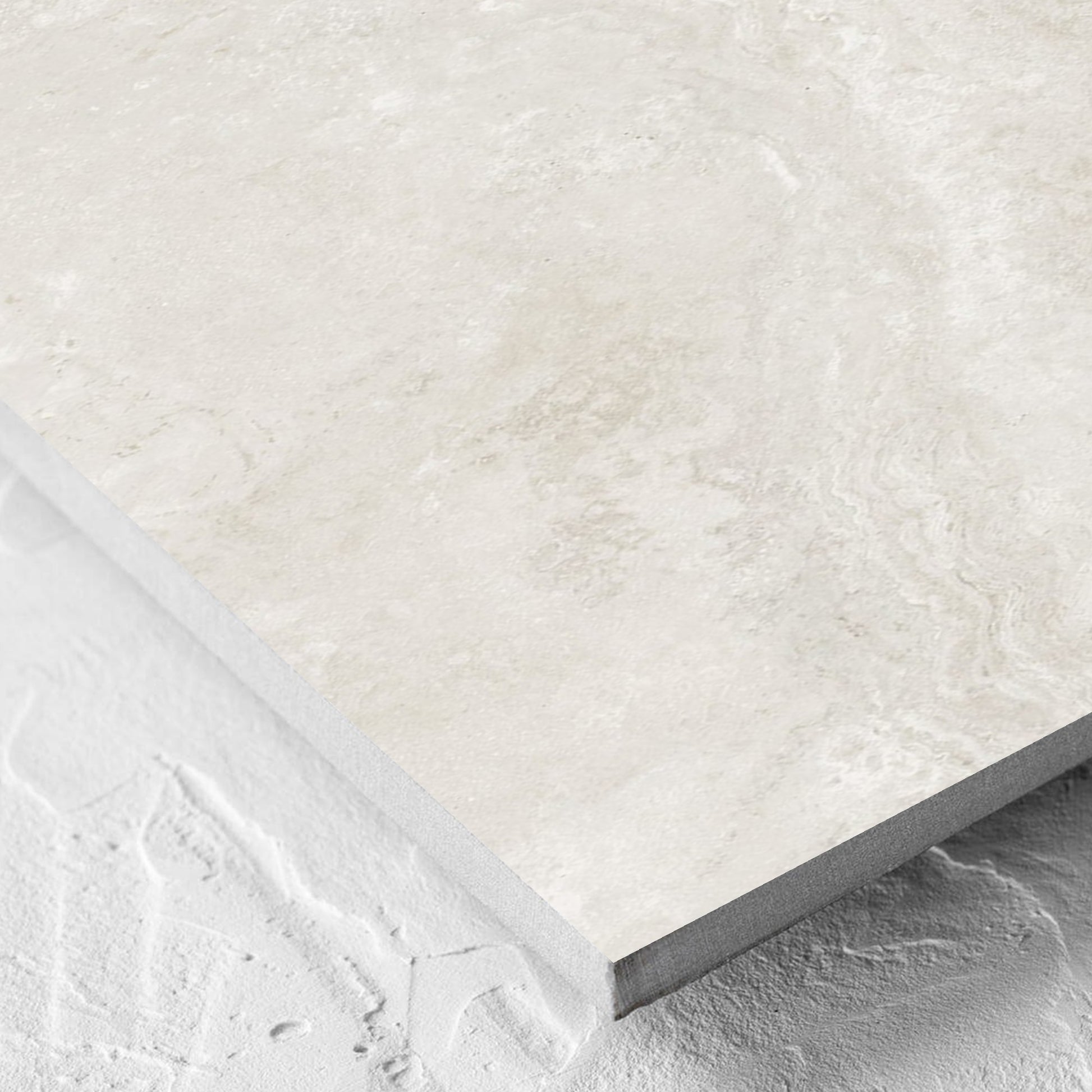 Corner close-up of the Norcia Travertine Light Decor 300x600mm tile showing the tile surface and the edge profile