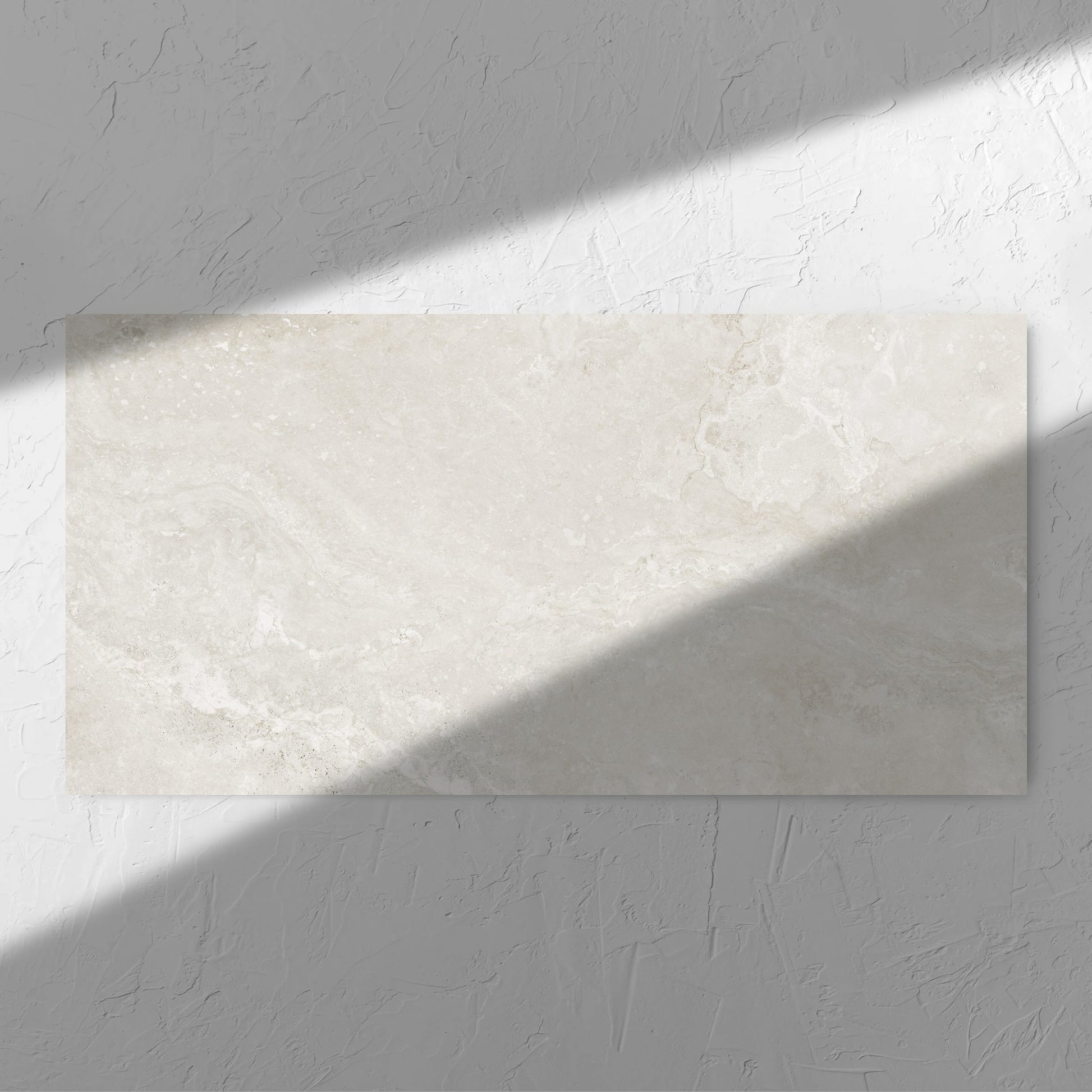 Norcia Travertine Light Honed 600x1200mm tile in soft natural window light, showing the light grey honed surface