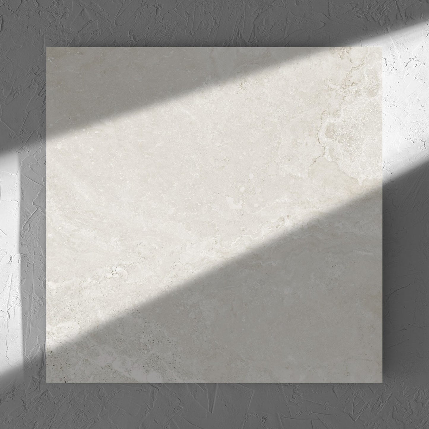 Norcia Travertine Light Honed 600x600mm tile in soft natural window light, showing the tile surface