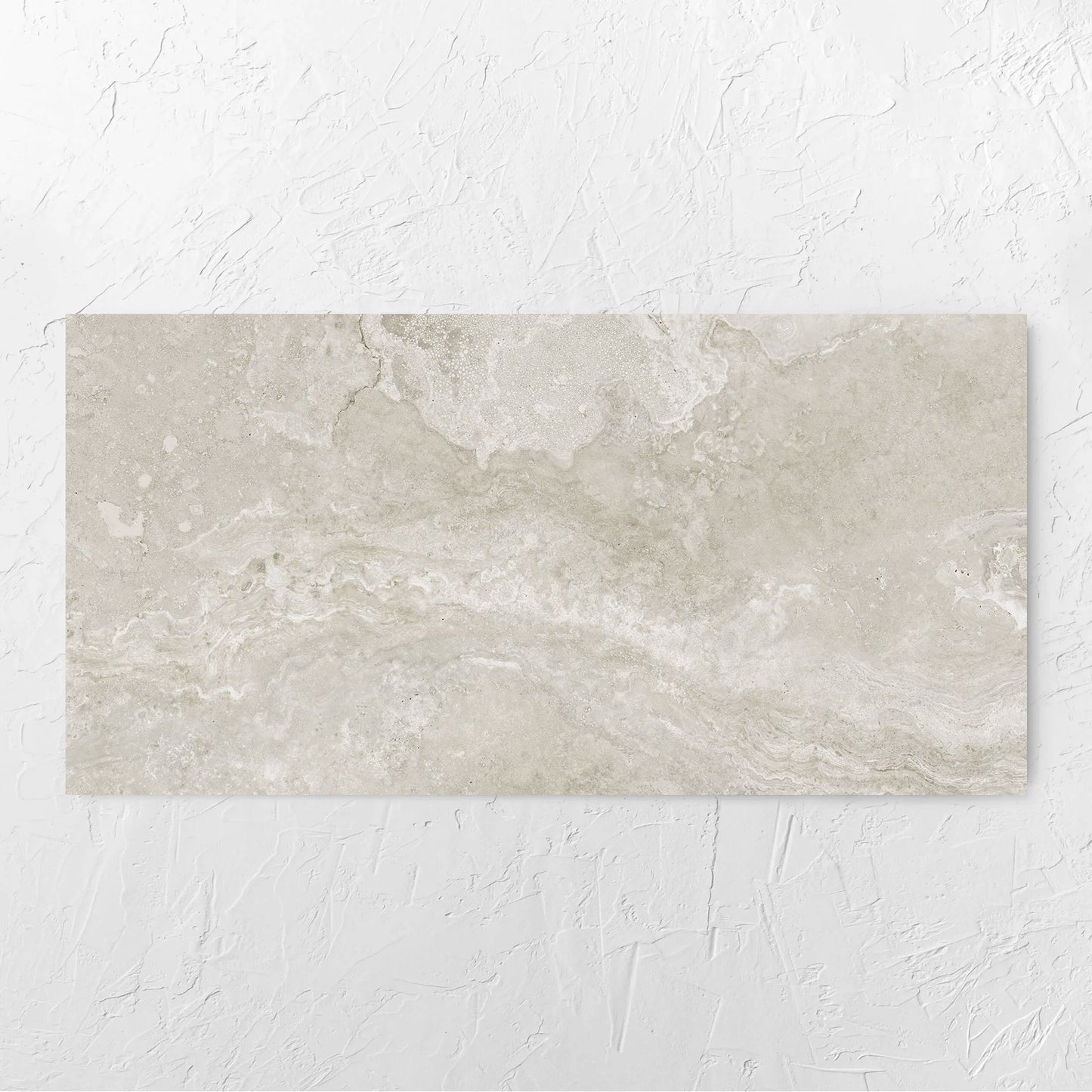 Norcia Travertine Silver 600x1200mm tile laid flat on a white rendered wall, showing the tile surface