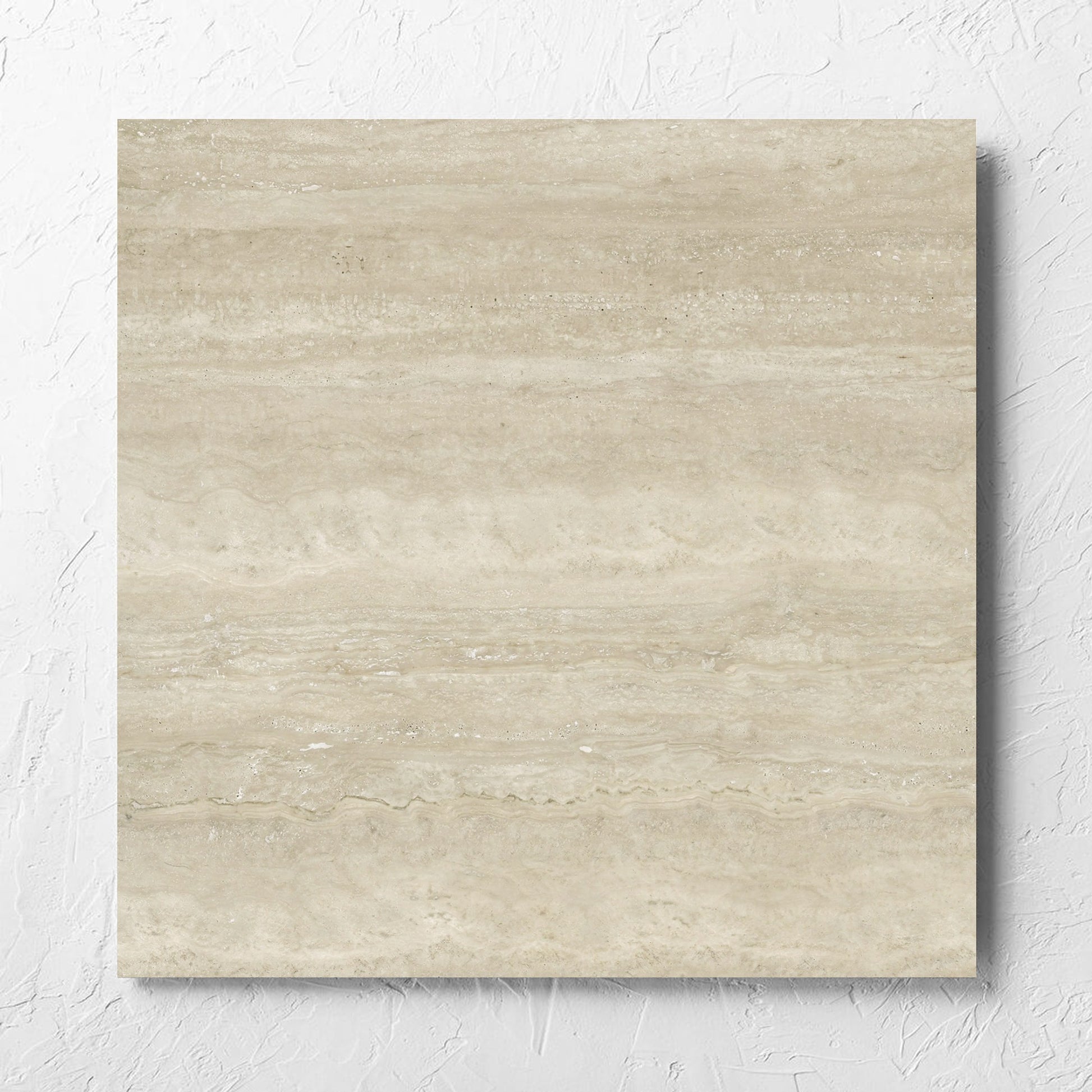 Norcia Vein Cut Beige 600x600mm tile laid flat on a white rendered wall, showing the beige matt surface