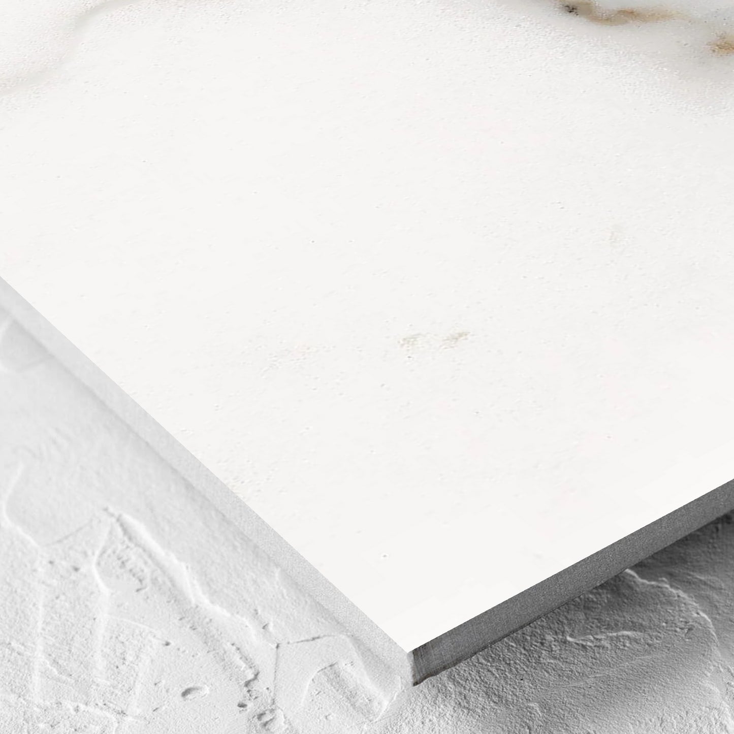 Corner close-up of the Nuovi Marmi Calacatta Gold Polished 600x600mm tile showing the matt surface and the edge profile