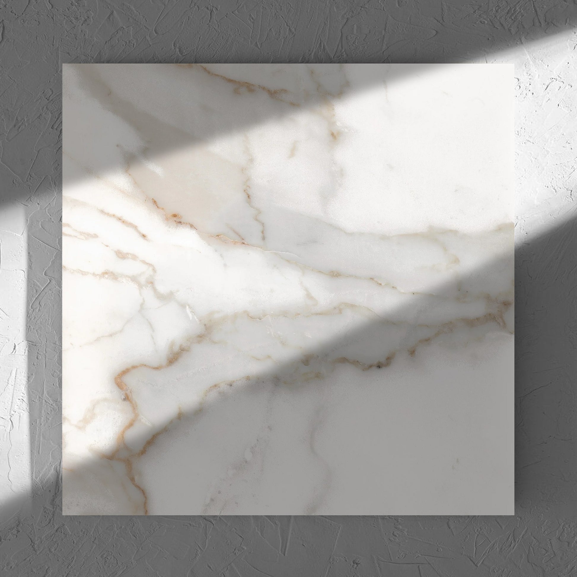 Nuovi Marmi Calacatta Gold Polished 600x600mm tile in soft natural window light, showing the matt surface