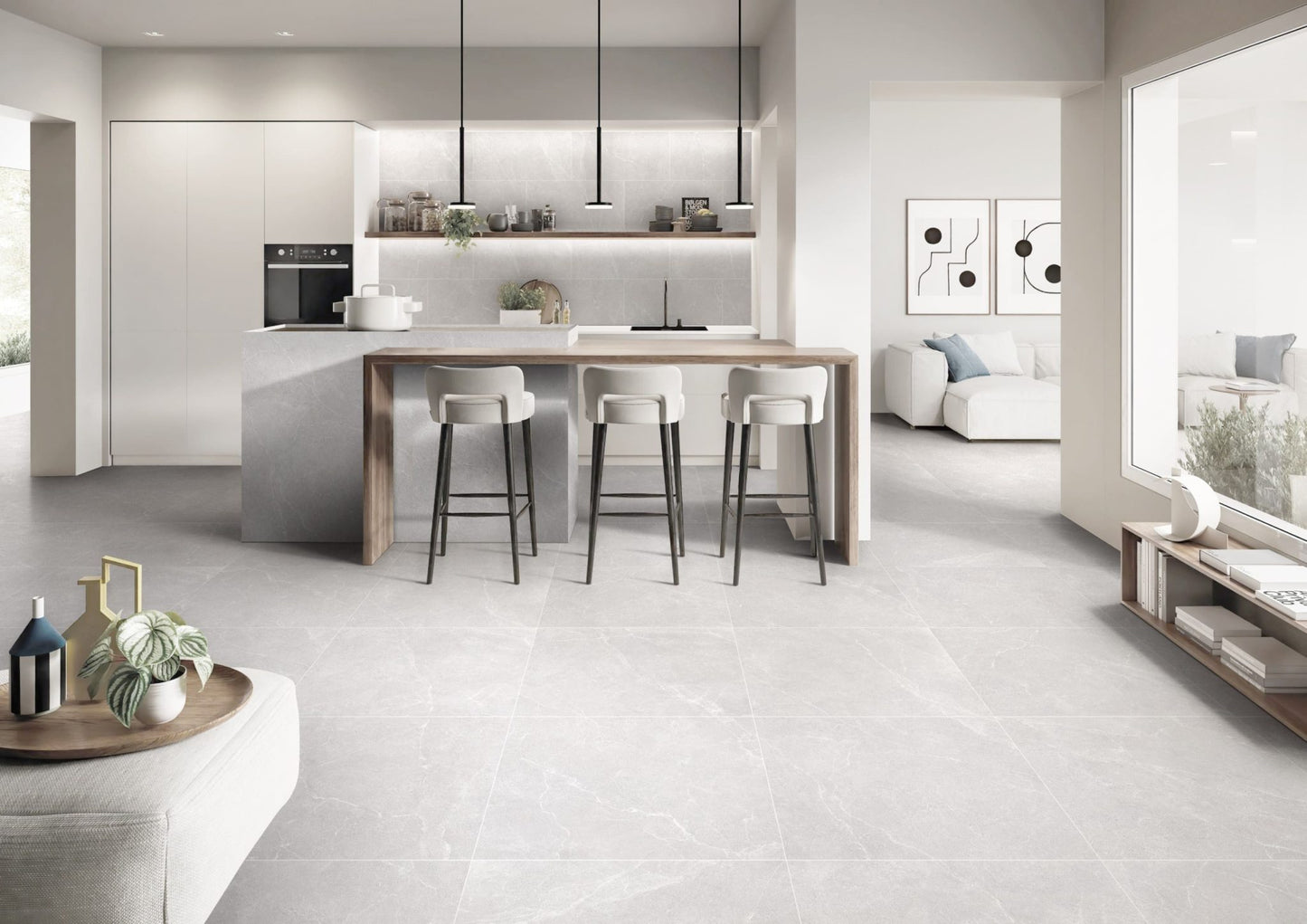 Oglio Silver Lappato 600x600mm tiles covering an open-plan kitchen and living area floor, complementing white cabinetry, a timber island bar, and black pendant lights.
