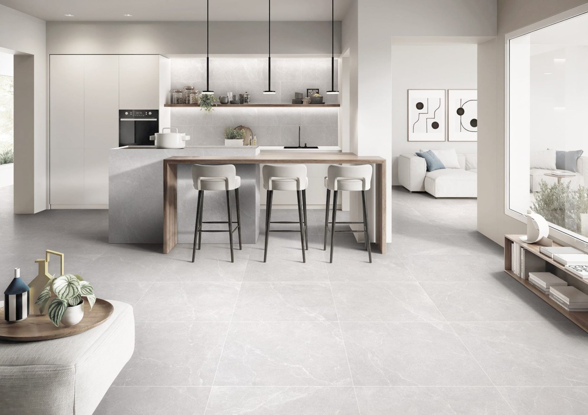 Oglio Silver Lappato 600x600mm tiles covering an open-plan kitchen and living area floor, complementing white cabinetry, a timber island bar, and black pendant lights.
