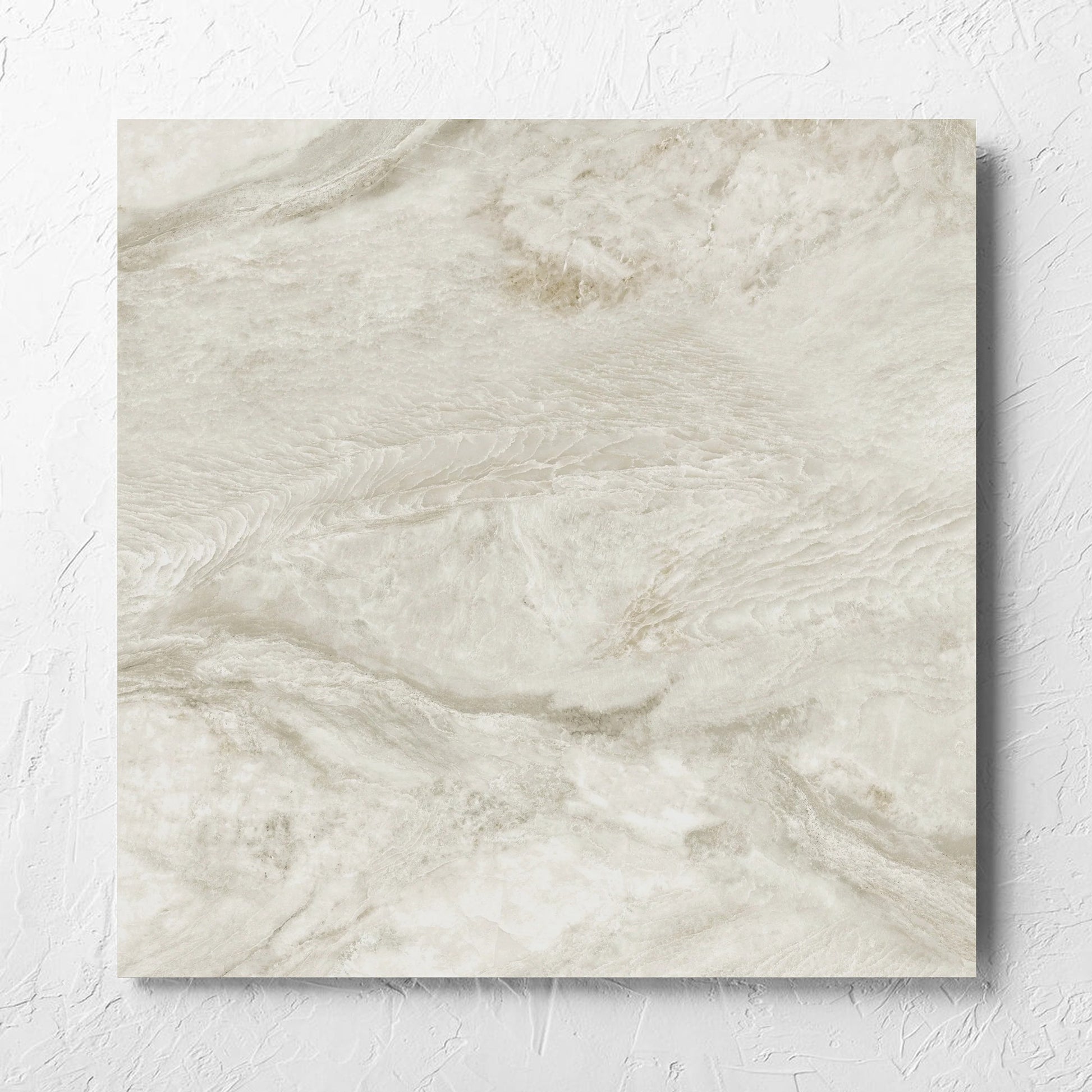 Onyx Beige Polished 600x600mm tile laid flat on a white rendered wall, showing the matt surface