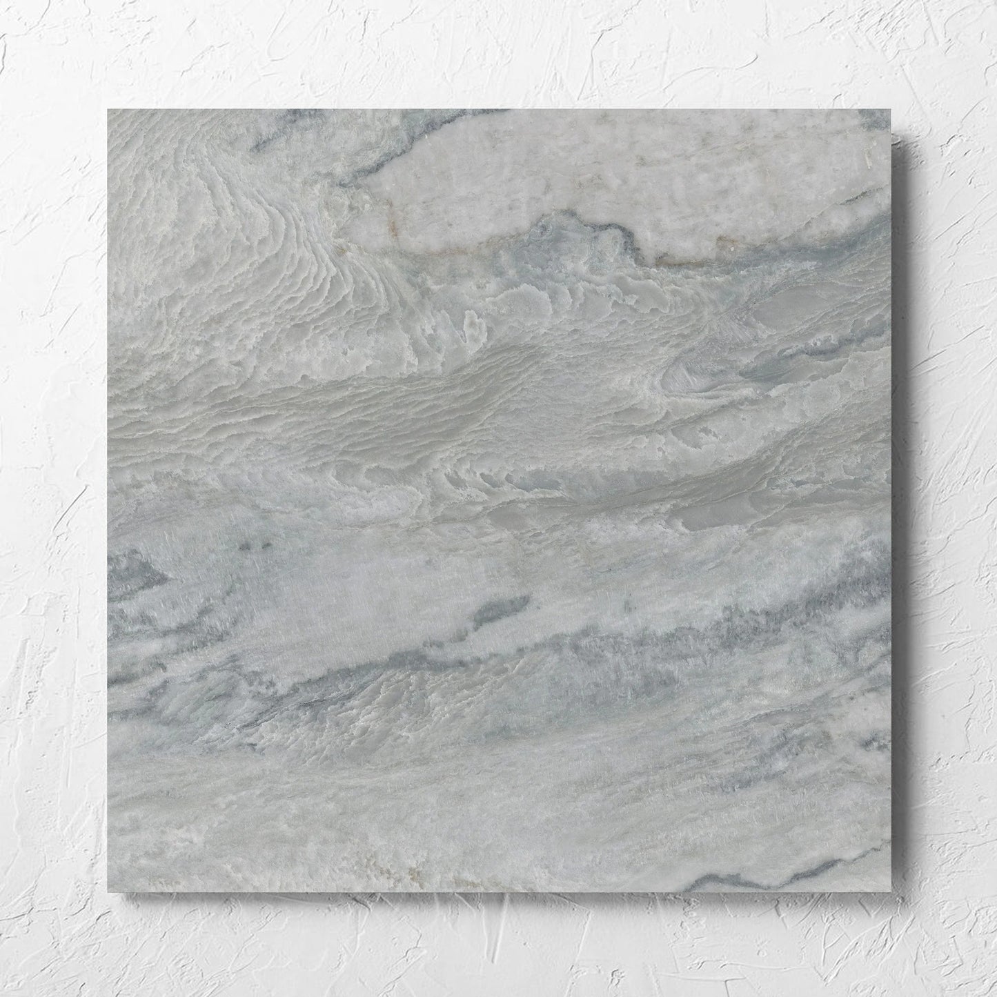 Onyx Grey Polished 600x600mm tile laid flat on a white rendered wall, showing the matt surface