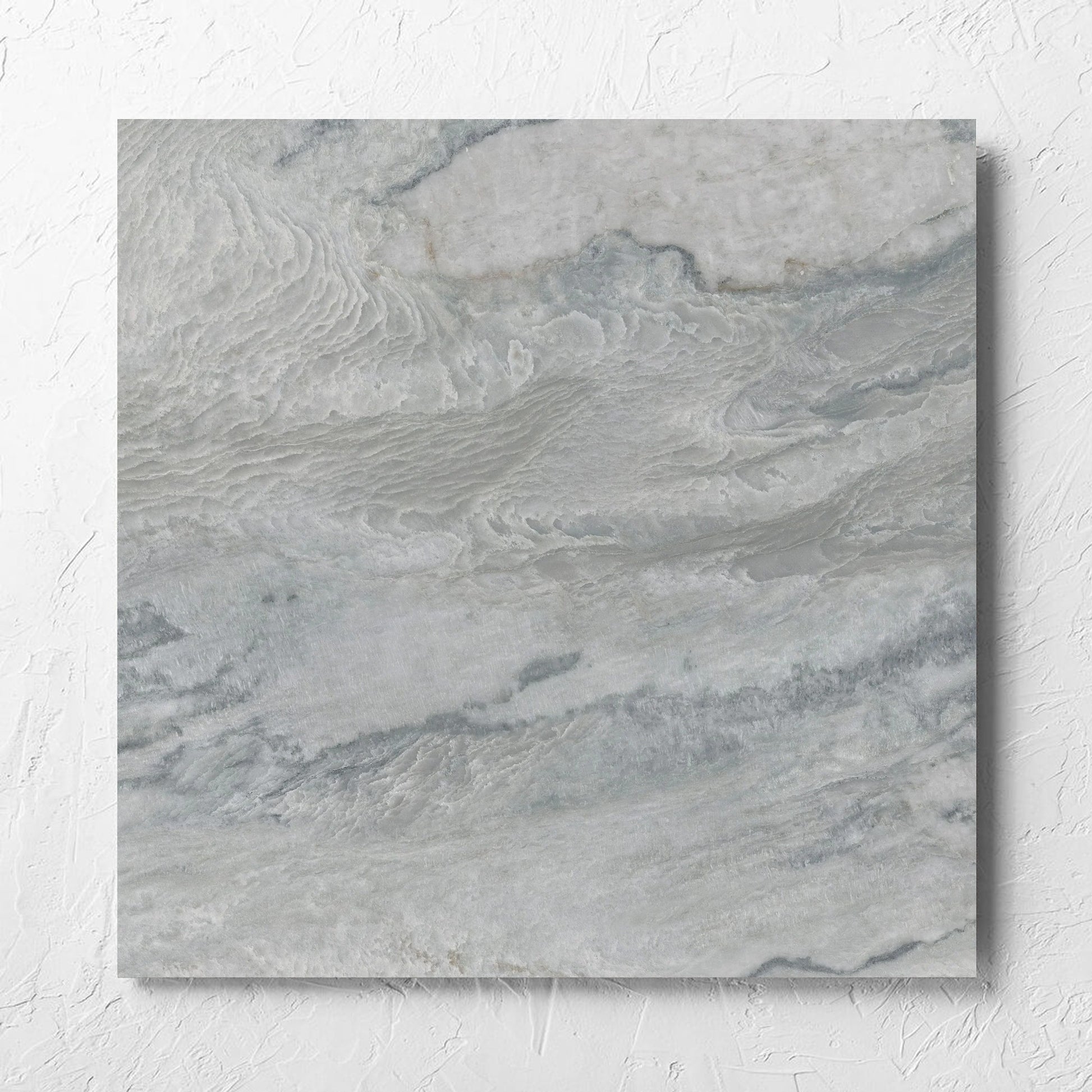 Onyx Grey Polished 600x600mm tile laid flat on a white rendered wall, showing the matt surface