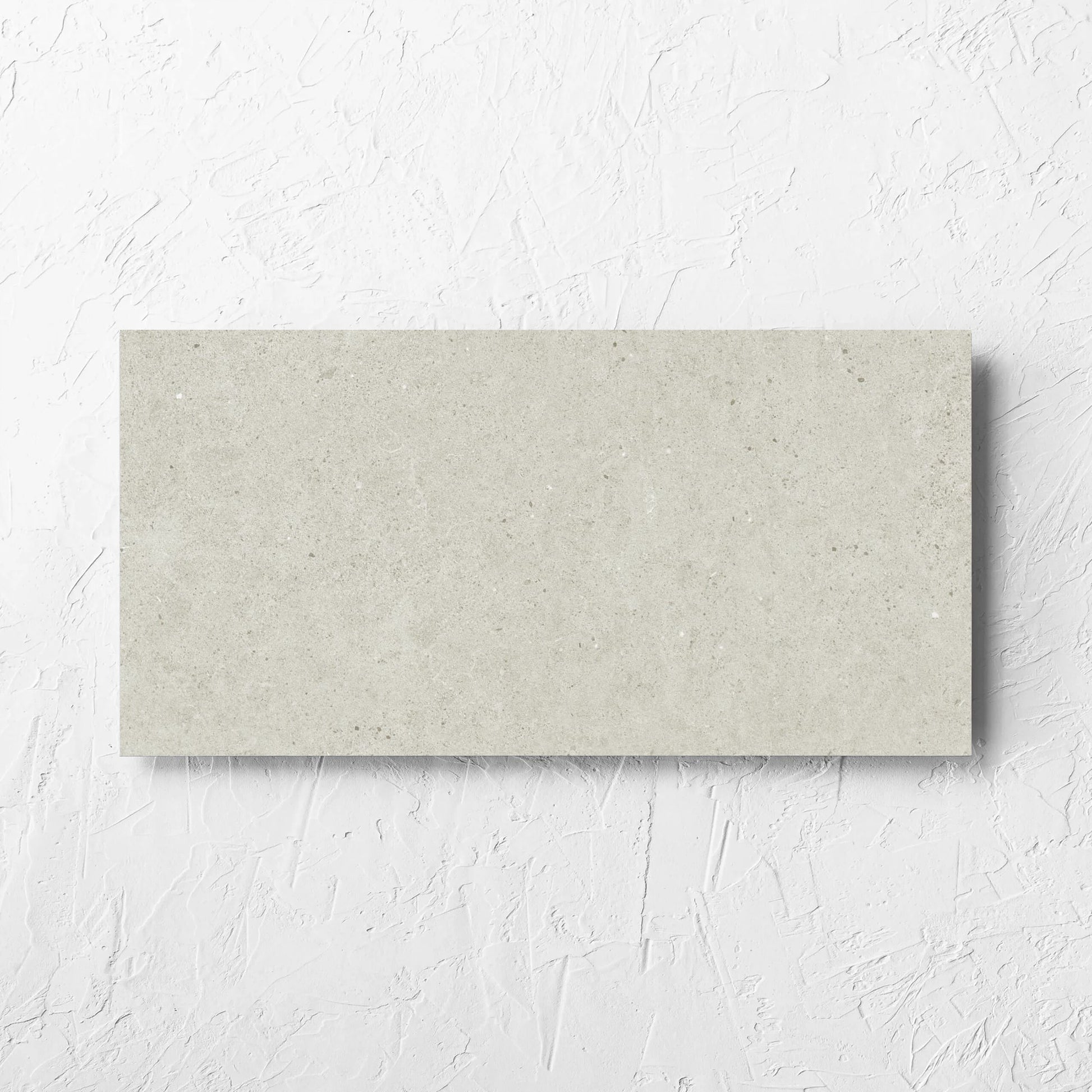 Organic Pietra Lavica Birch 300x600mm tile laid flat on a white rendered wall, showing the tile surface