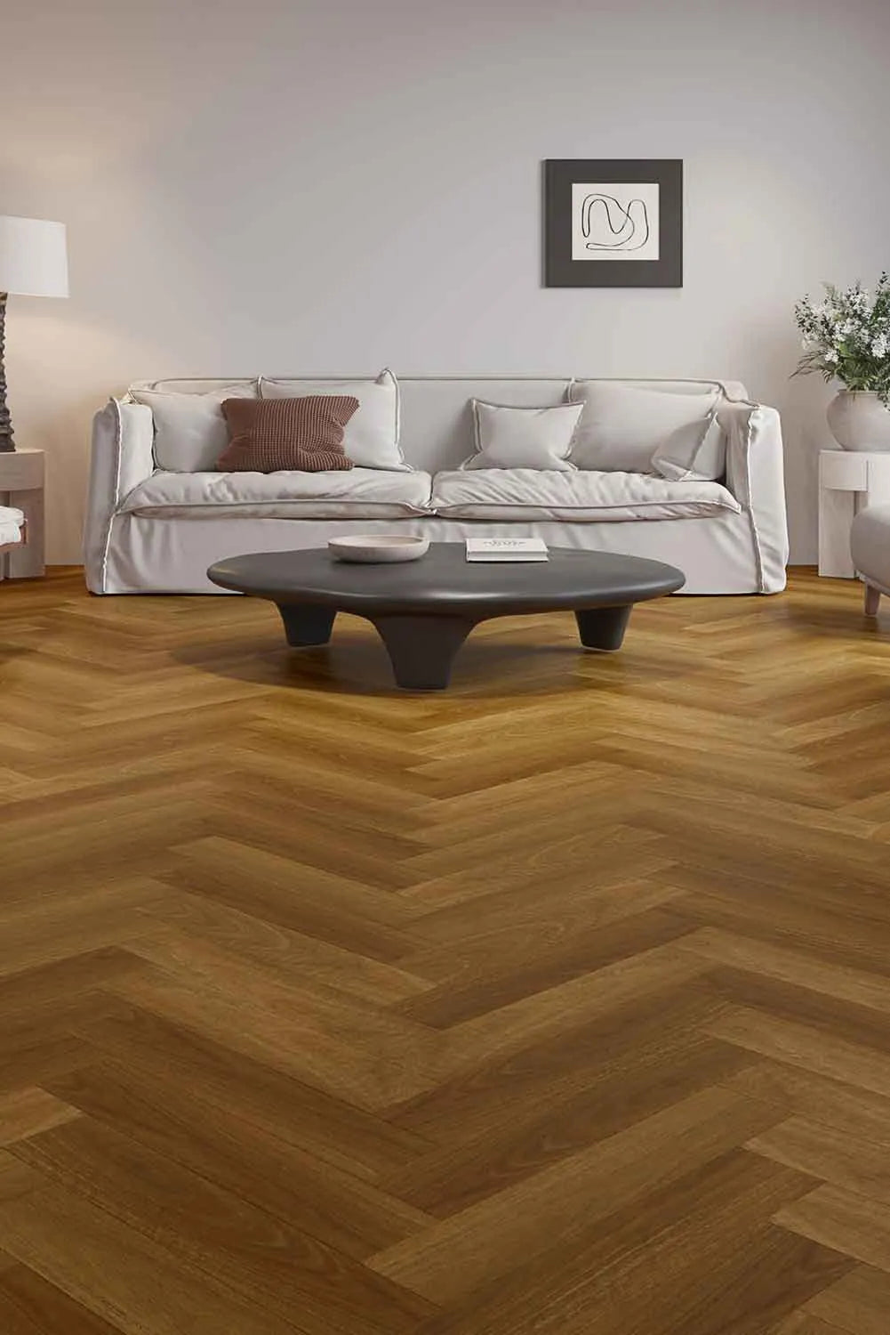 Pacific Spotted Gum Elegant SPC Hybrid Herringbone 9.5mm Flooring 7.5+2mm installed in a modern living room with a white sofa and dark coffee table.