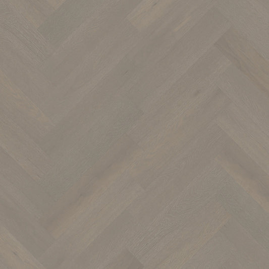 Close-up texture shot of Pale Oak iDesign Herringbone Flooring 15/3mm showing a grey-toned oak wood grain in a diagonal herringbone pattern.