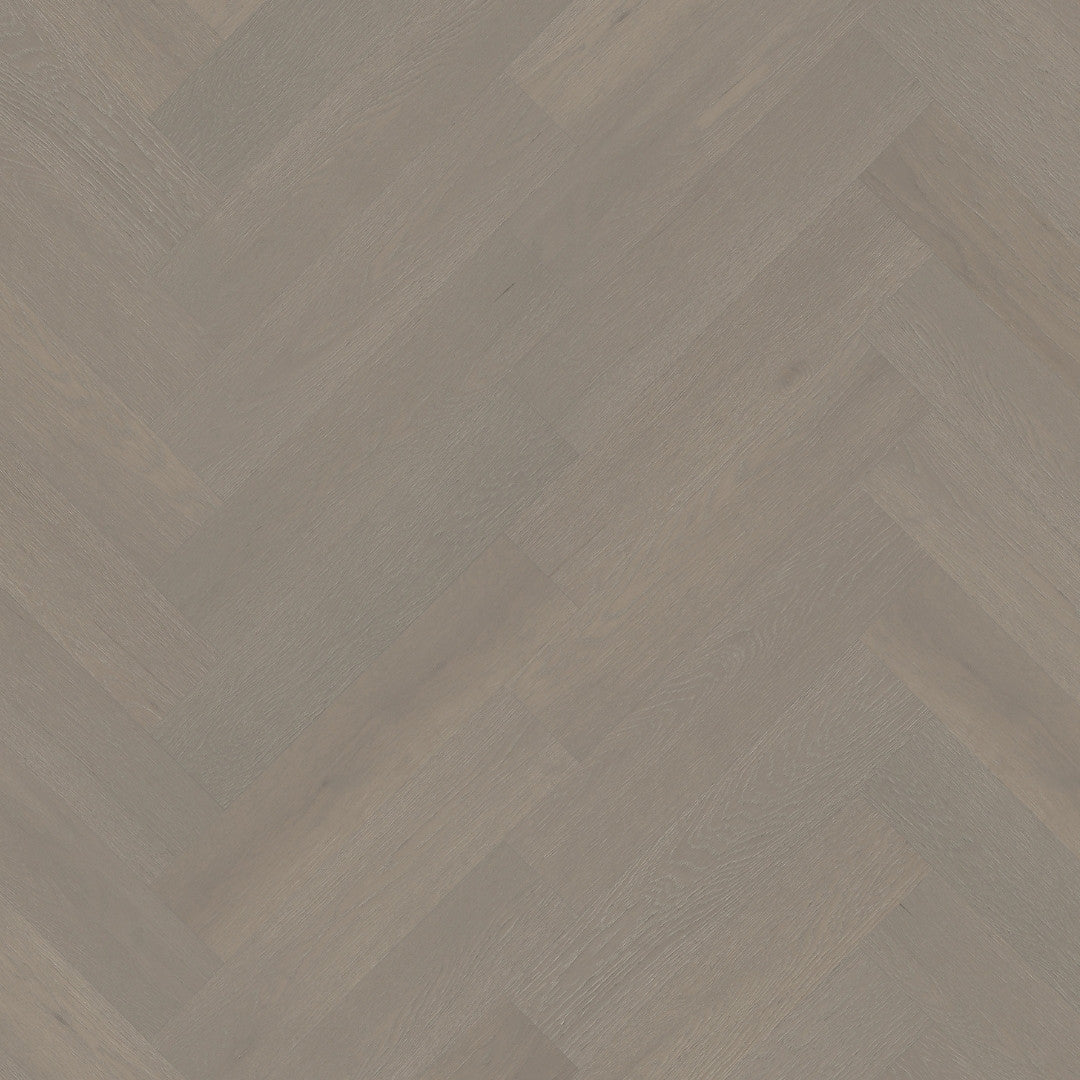 Close-up texture shot of Pale Oak iDesign15 Oak Flooring 15/3mm showing a grey-toned herringbone pattern with subtle wood grain detail.
