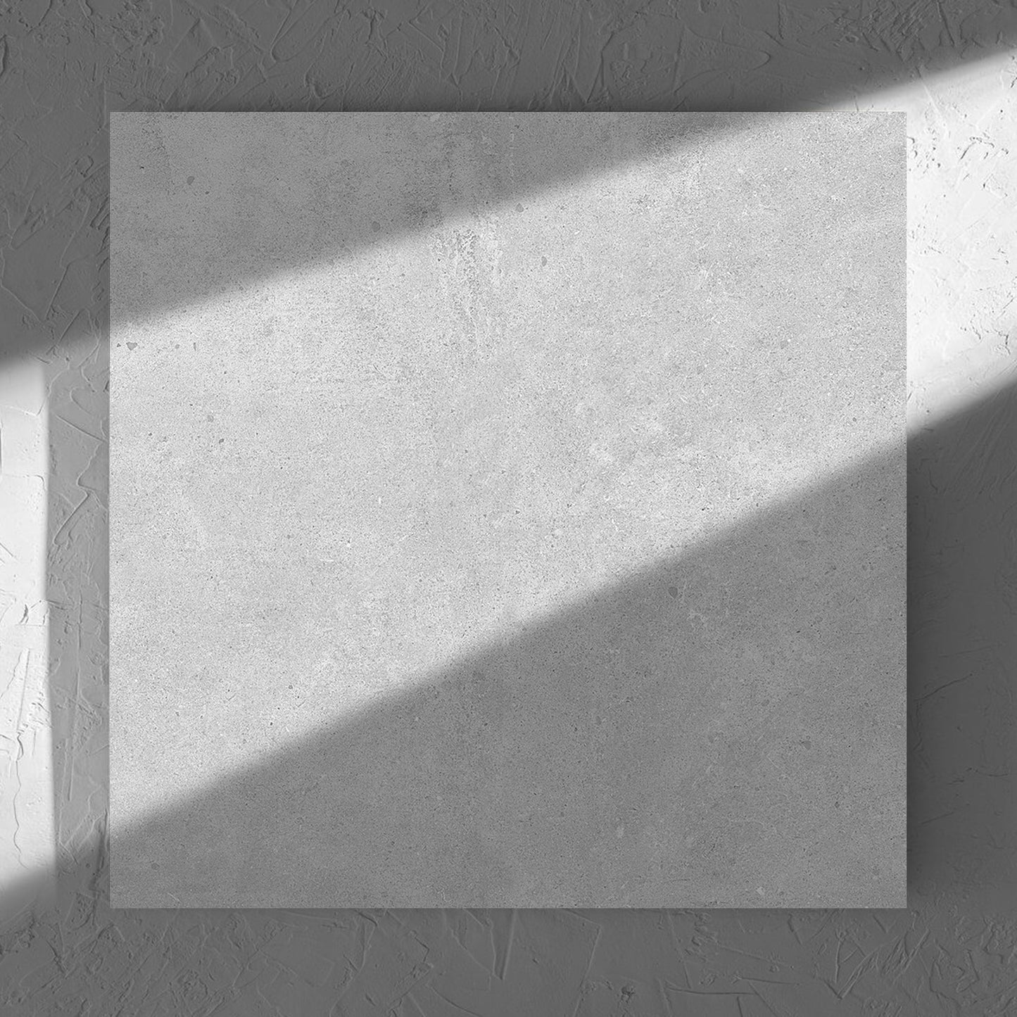 Paradigm Light Grey Structured Paver 600x600x20mm tile in soft natural window light, showing the tile surface