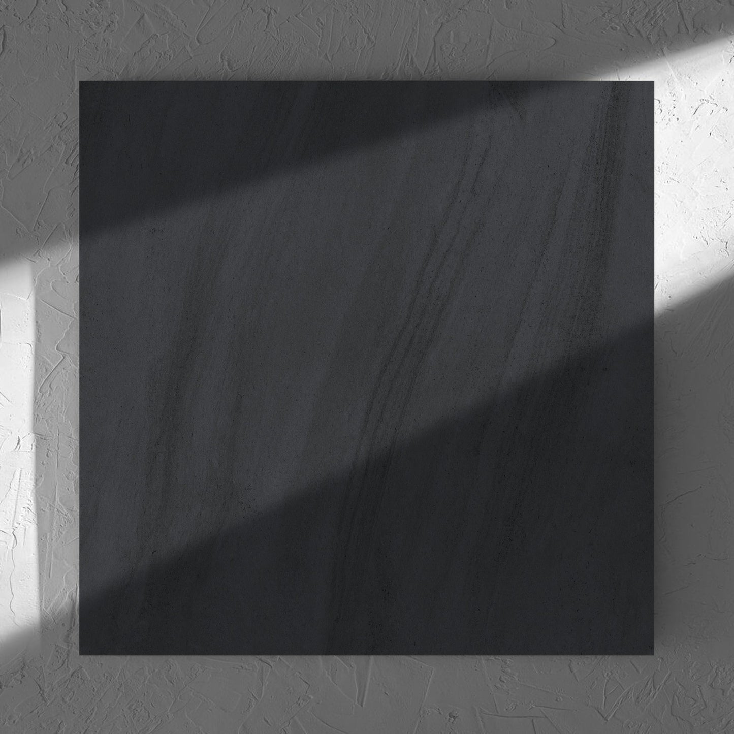 Paris Noir Matt 600x600mm tile in soft natural window light, showing the matt surface