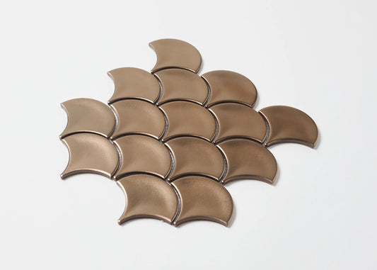 Pack shot of PGFS-0009 Bronze Metal Plated Matte Glazed Porcelain Fishscale tiles arranged in an overlapping scale pattern with a warm copper-bronze metallic matte finish.