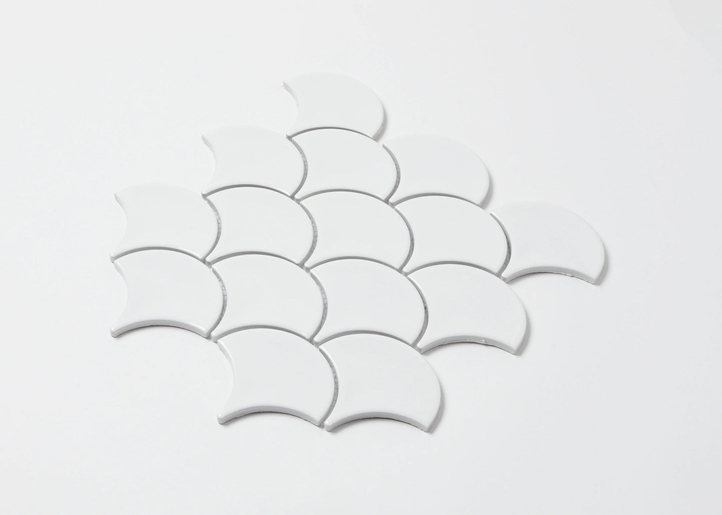 Pack shot of PGFS-3051 White Gloss Glazed Porcelain Fishscale 95x87mm tiles arranged in an overlapping scallop pattern against a white background.