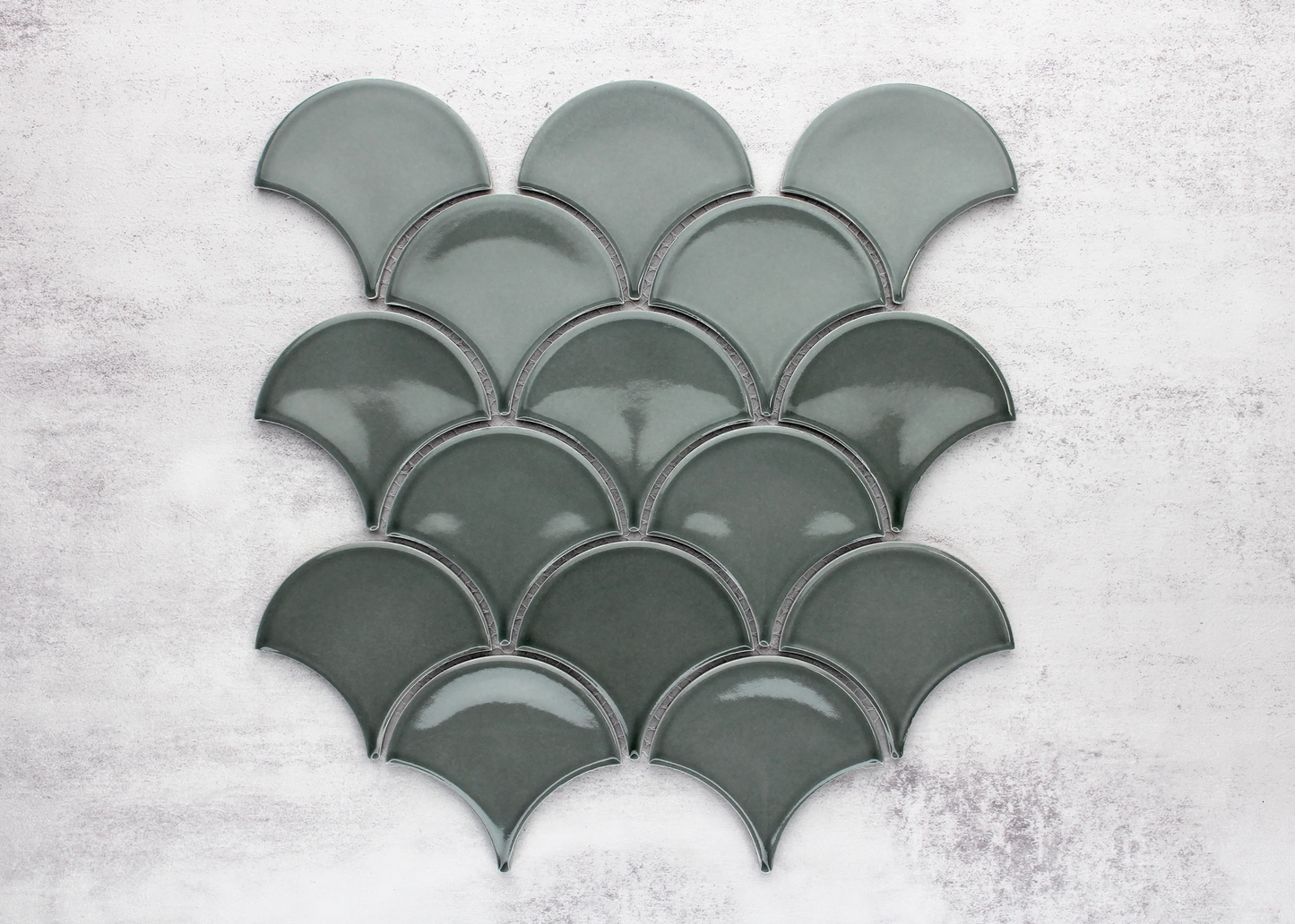 Pack shot of PGFS-8182 Water Green Gloss Glazed Porcelain Fishscale 95x87mm tiles arranged in an overlapping scallop pattern showing their glossy teal-green finish and fan shape.