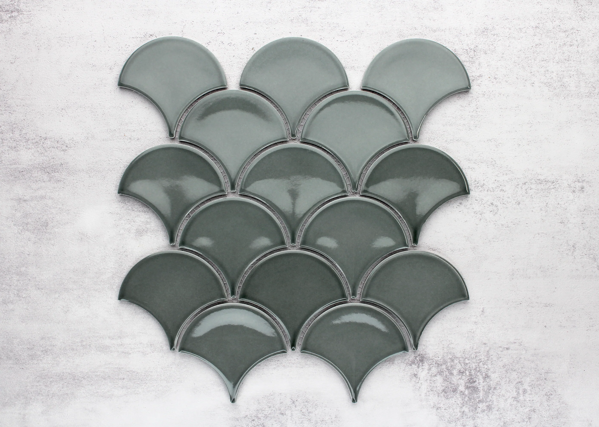 Pack shot of PGFS-8182 Water Green Gloss Glazed Porcelain Fishscale 95x87mm tiles arranged in an overlapping scallop pattern showing their glossy teal-green finish and fan shape.