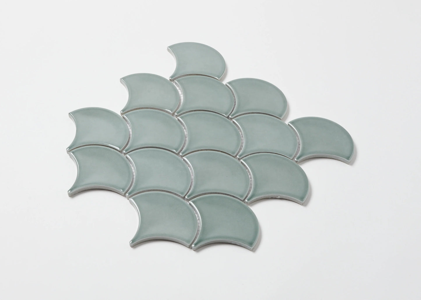 Pack shot of PGFS-8182 Water Green Gloss Glazed Porcelain Fishscale 95x87mm tiles arranged in an overlapping scale pattern with a soft aqua gloss finish.