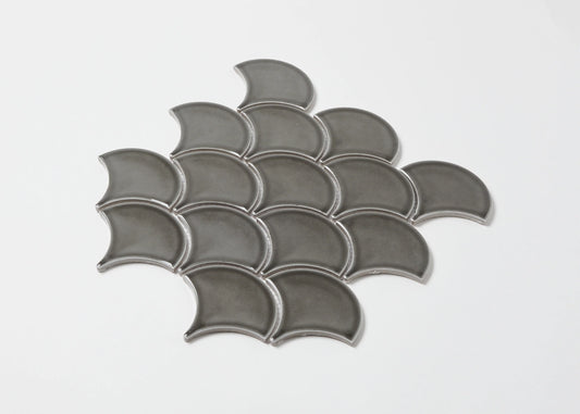 Pack shot of PGFS-8874 Charcoal Gloss Glazed Porcelain Fishscale 95x87mm tiles arranged in an overlapping fish scale pattern with a glossy grey finish.