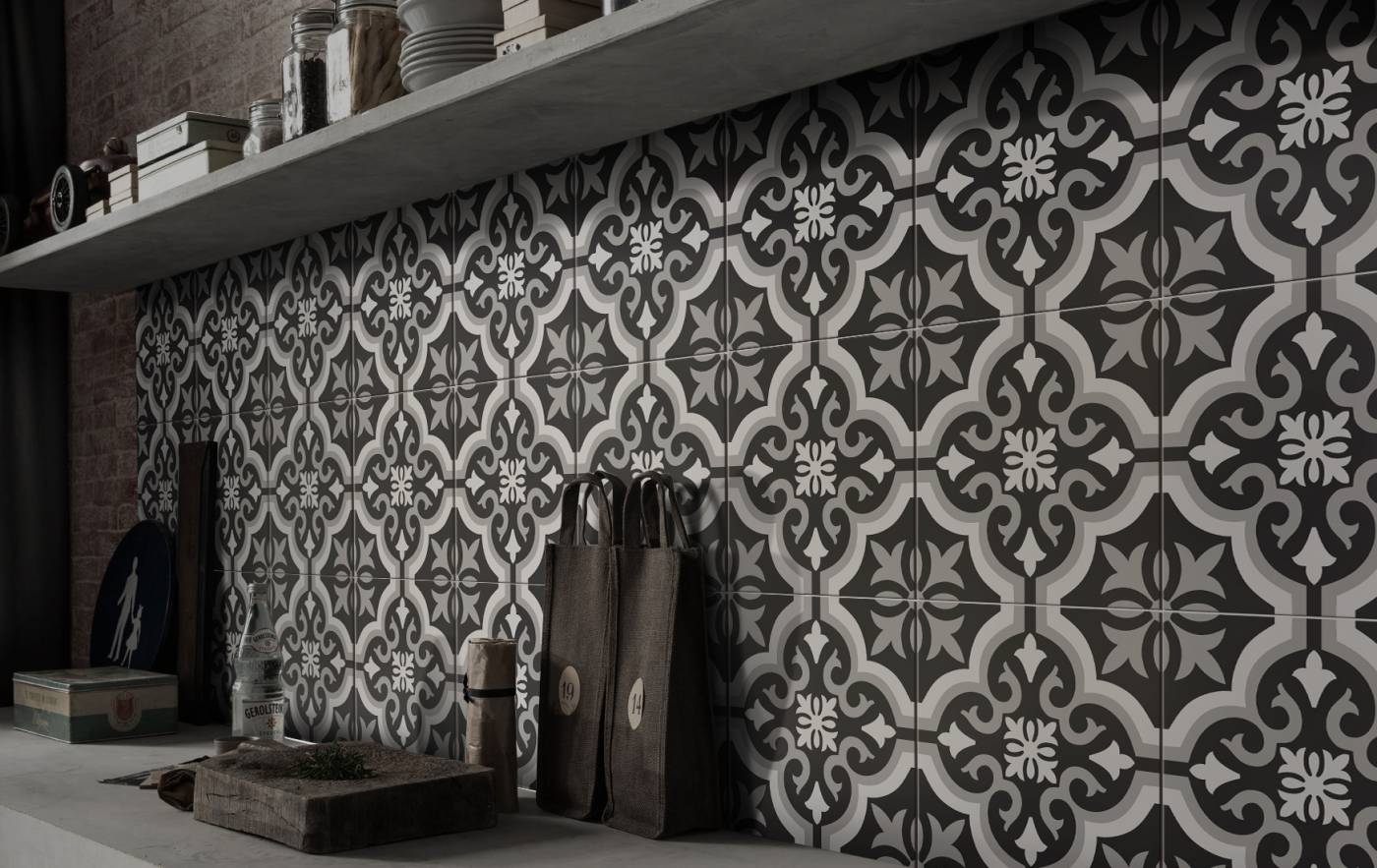 Picasso Classic Mid 200x200mm patterned wall tiles in monochrome grey and white installed floor-to-ceiling in a kitchen with floating concrete shelf and leather bags.