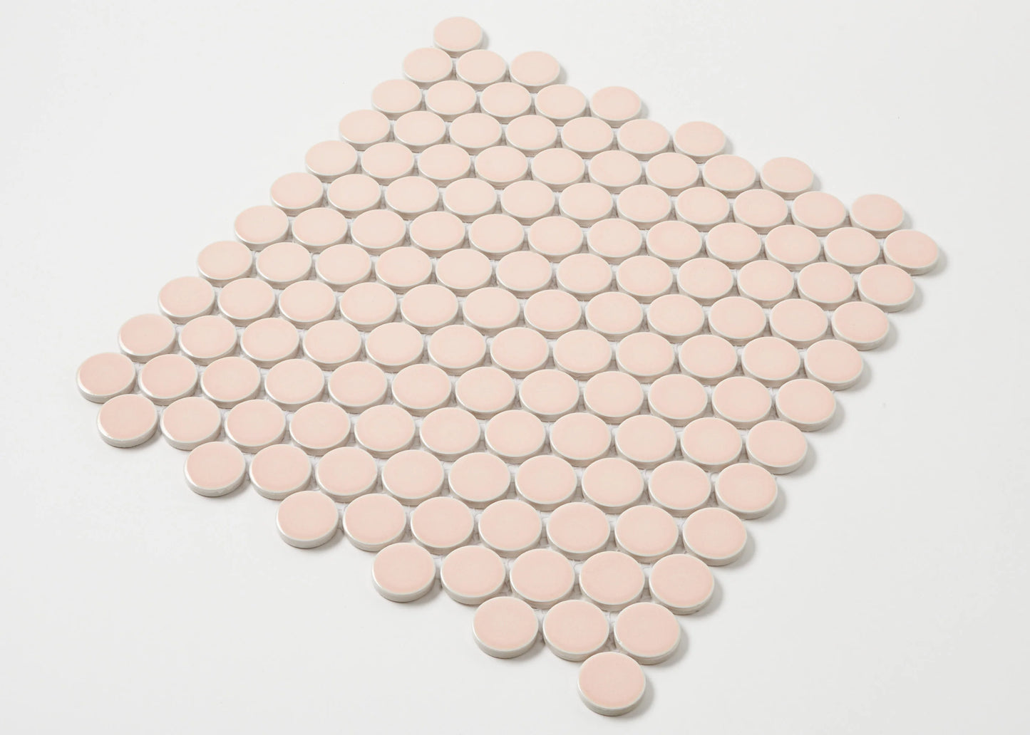 Pack shot of Pink Gloss Glazed Porcelain Penny Round 28mm Diameter tiles arranged in a diamond-shaped mosaic sheet with white grout joints.