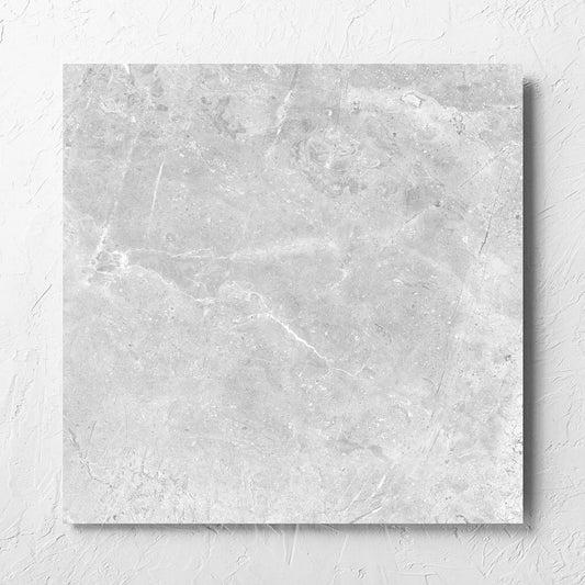 Potifino Oyster Matt 600x600mm tile laid flat on a white rendered wall, showing the matt surface