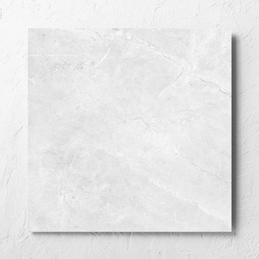 Potifino White Matt 600x600mm tile laid flat on a white rendered wall, showing the matt surface
