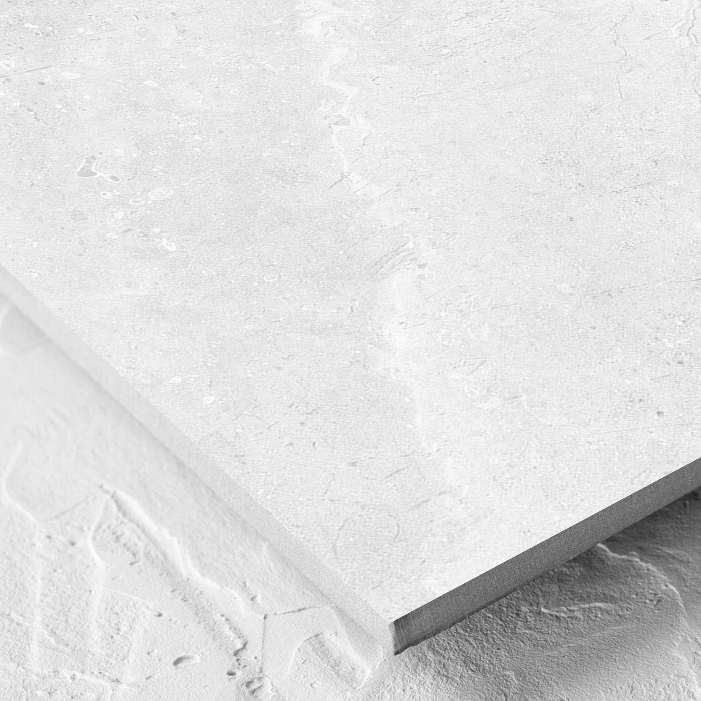 Corner close-up of the Potifino White Polished 600x600mm tile showing the matt surface and the edge profile