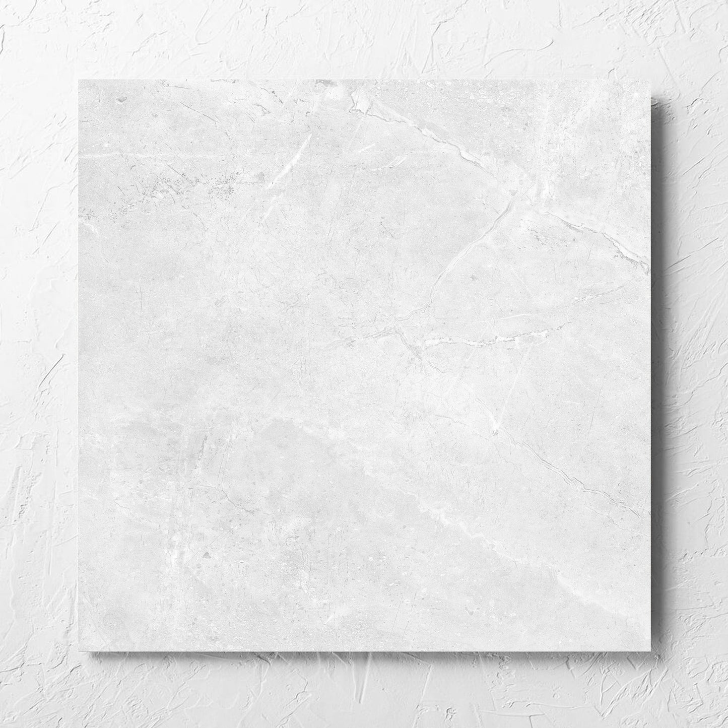 Potifino White Polished 600x600mm tile laid flat on a white rendered wall, showing the matt surface