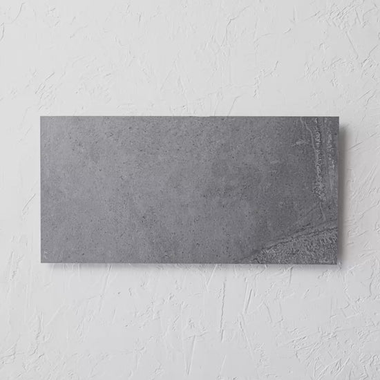 Zeus Charcoal Matt 300X600 tile shown in hand